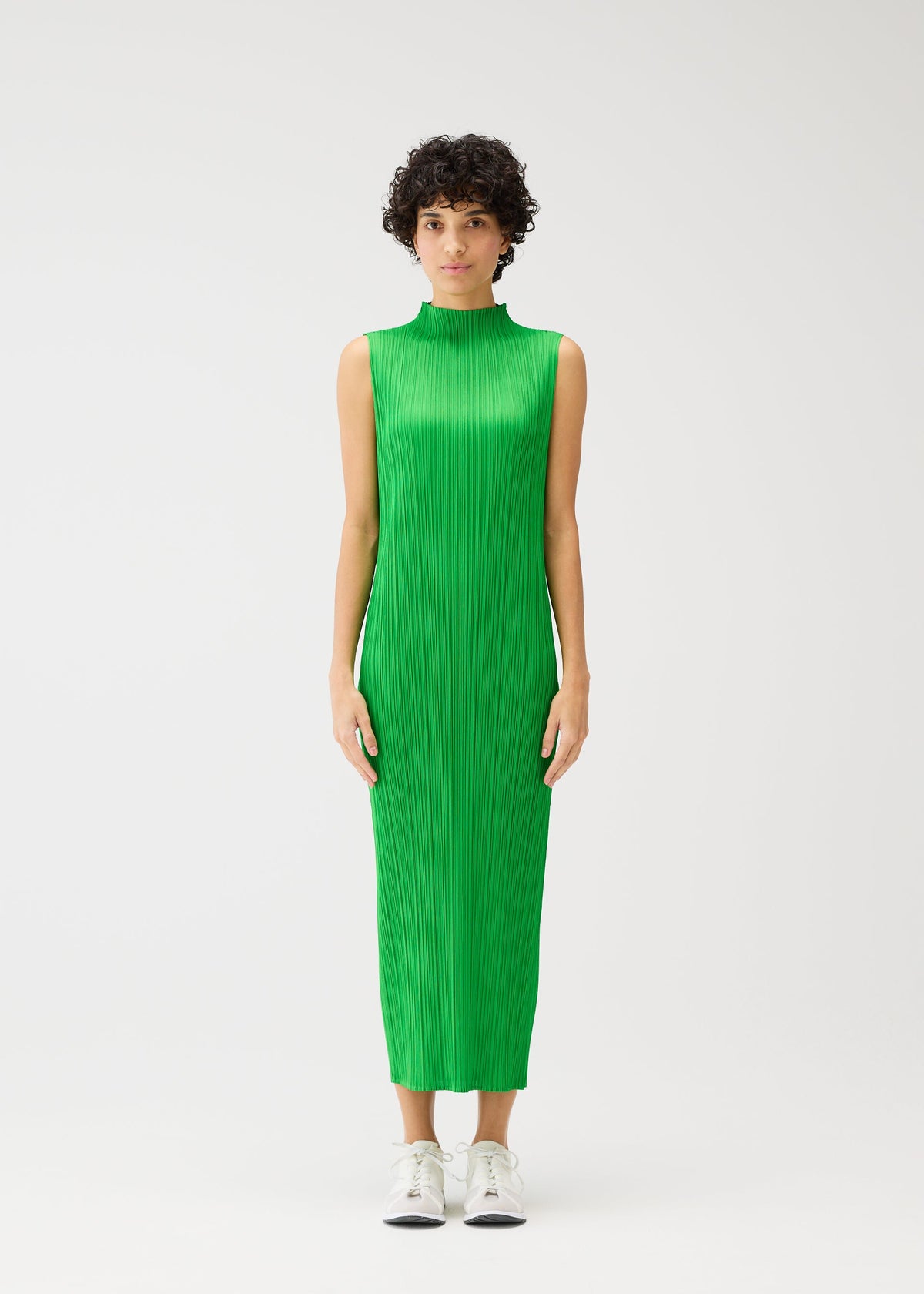 A model wears the PLEATS PLEASE ISSEY MIYAKE MONTHLY COLORS APRIL dress.