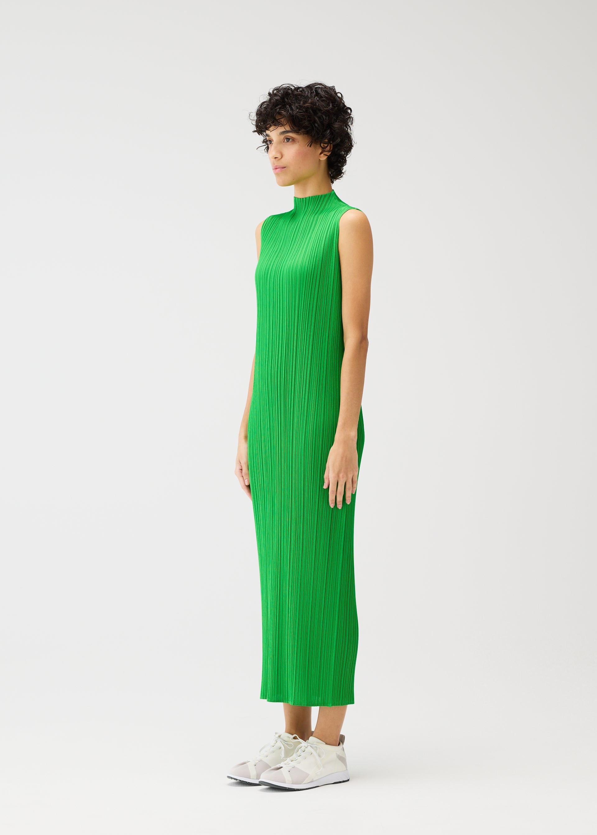 A model wears the PLEATS PLEASE ISSEY MIYAKE MONTHLY COLORS APRIL dress.