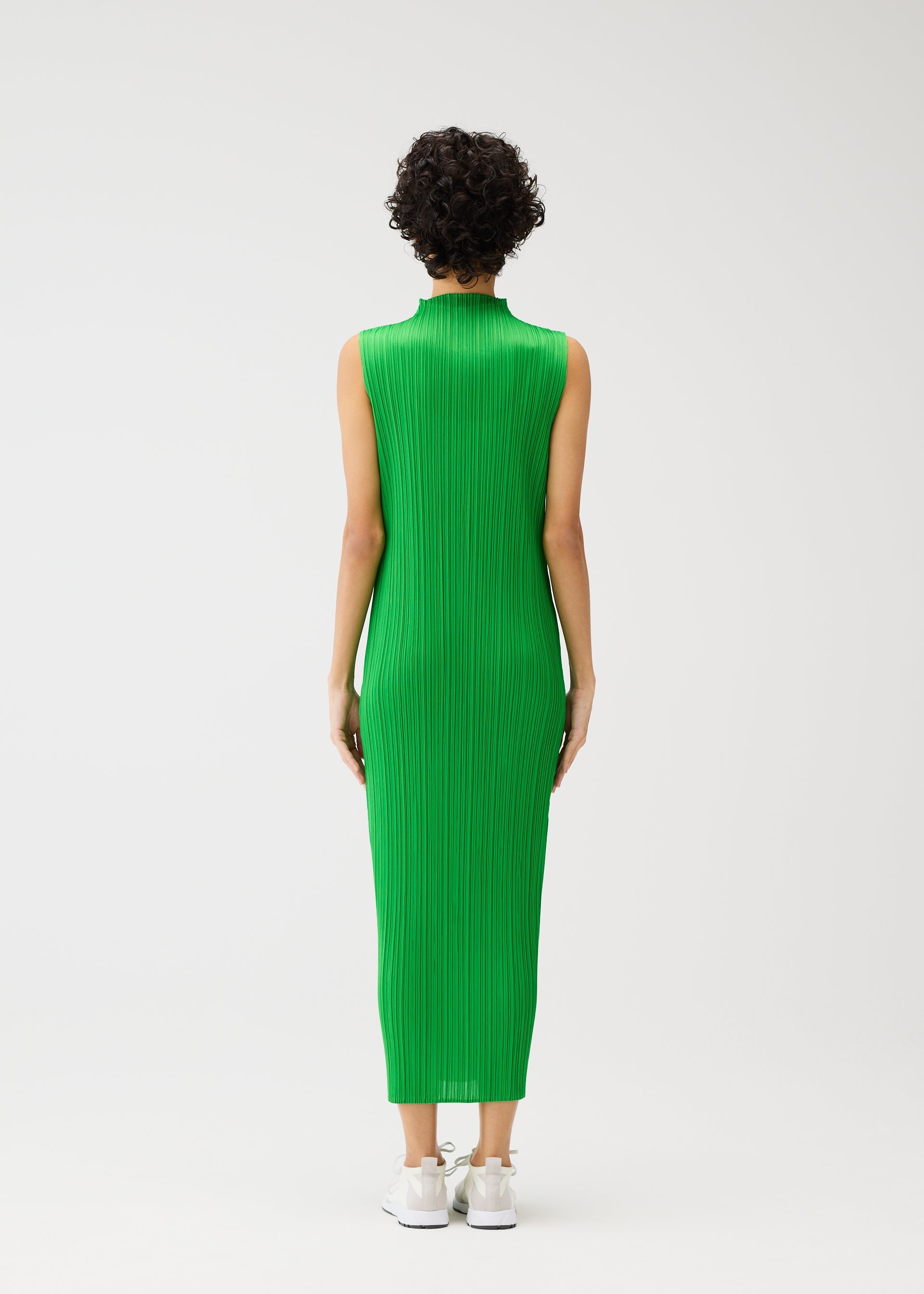 A model wears the PLEATS PLEASE ISSEY MIYAKE MONTHLY COLORS APRIL dress.