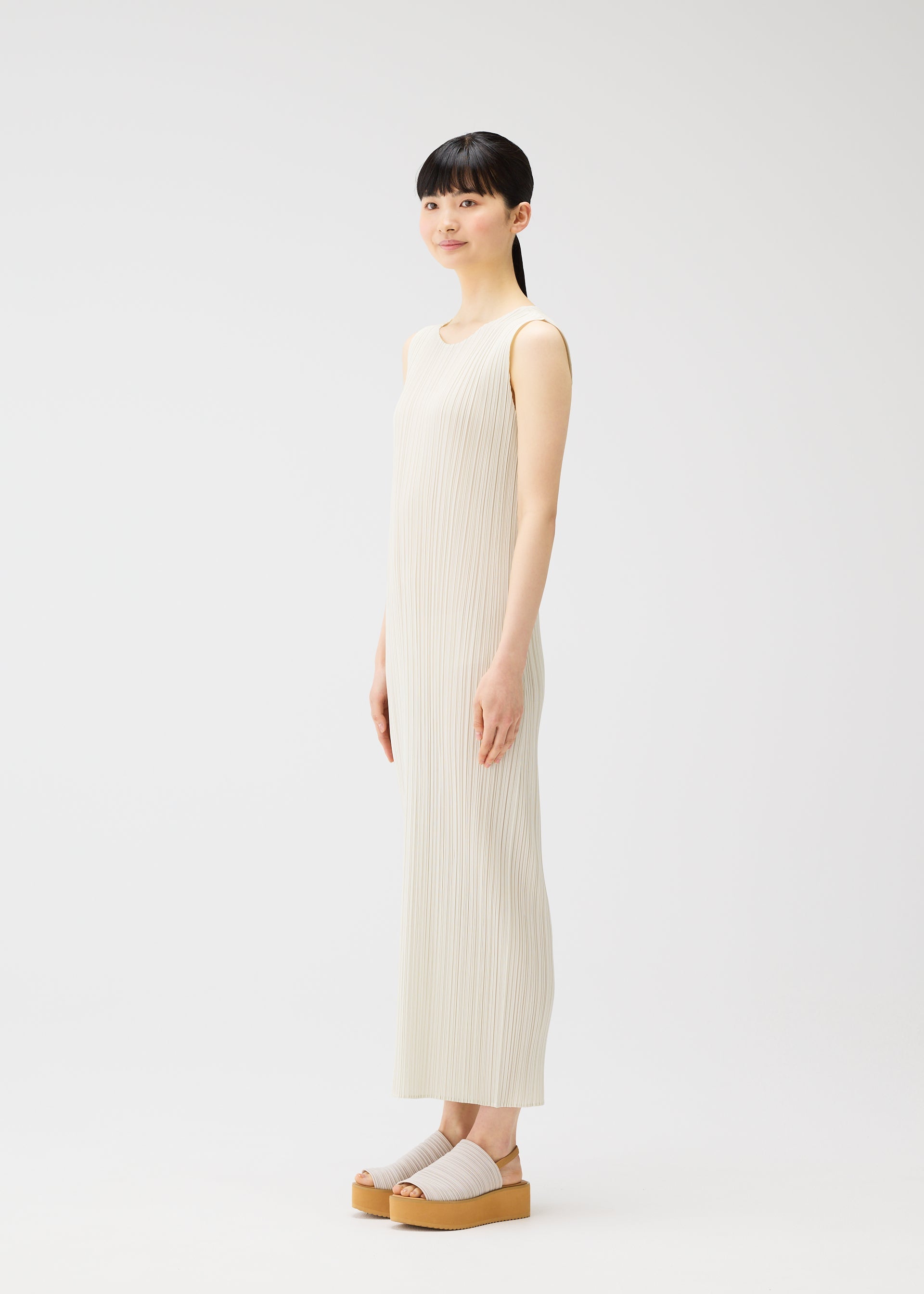A model wears the PLEATS PLEASE ISSEY MIYAKE MONTHLY COLORS MAY dress.