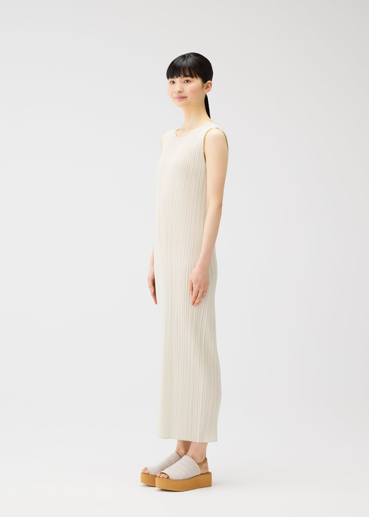 A model wears the PLEATS PLEASE ISSEY MIYAKE MONTHLY COLORS MAY dress.