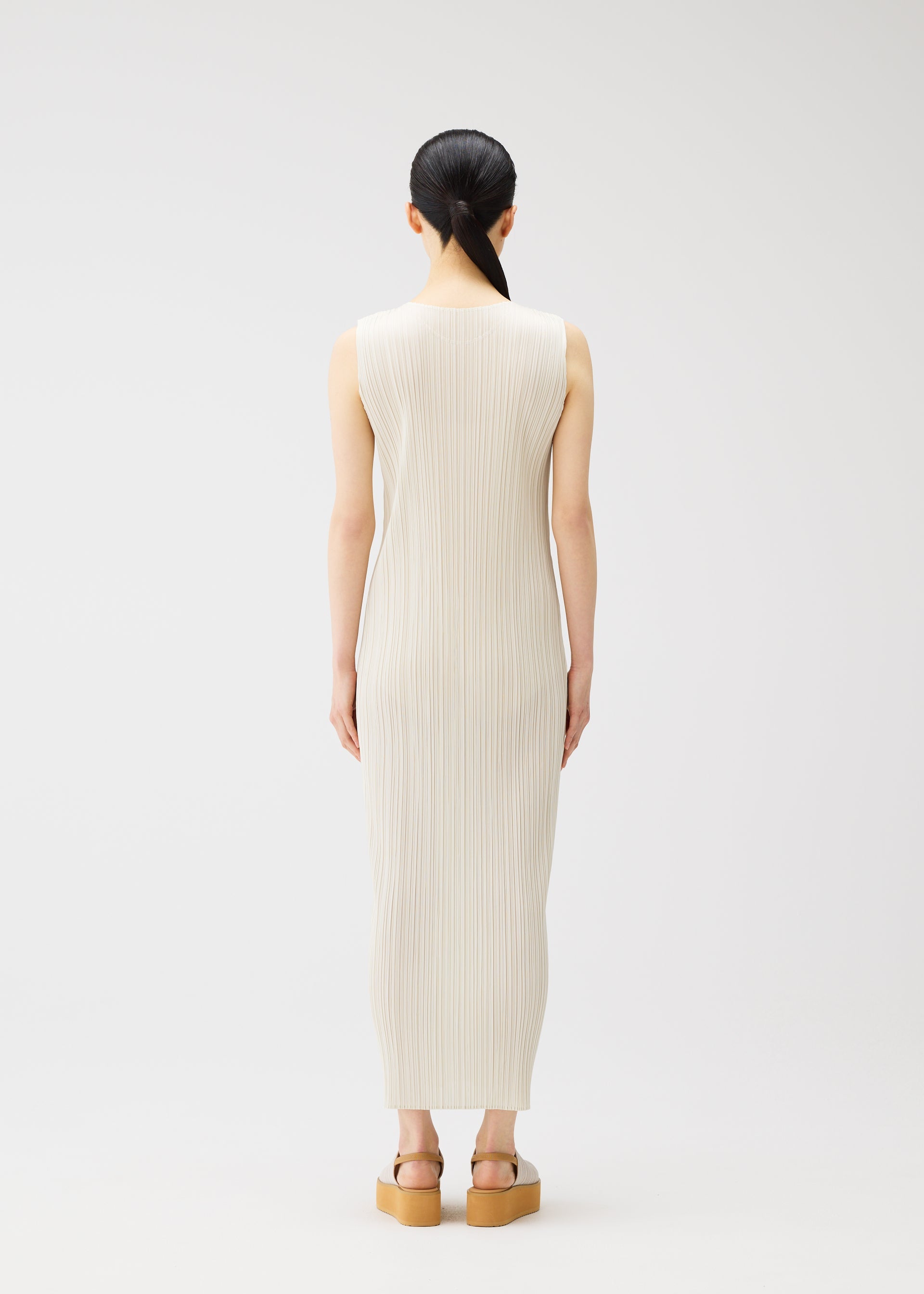 A model wears the PLEATS PLEASE ISSEY MIYAKE MONTHLY COLORS MAY dress.