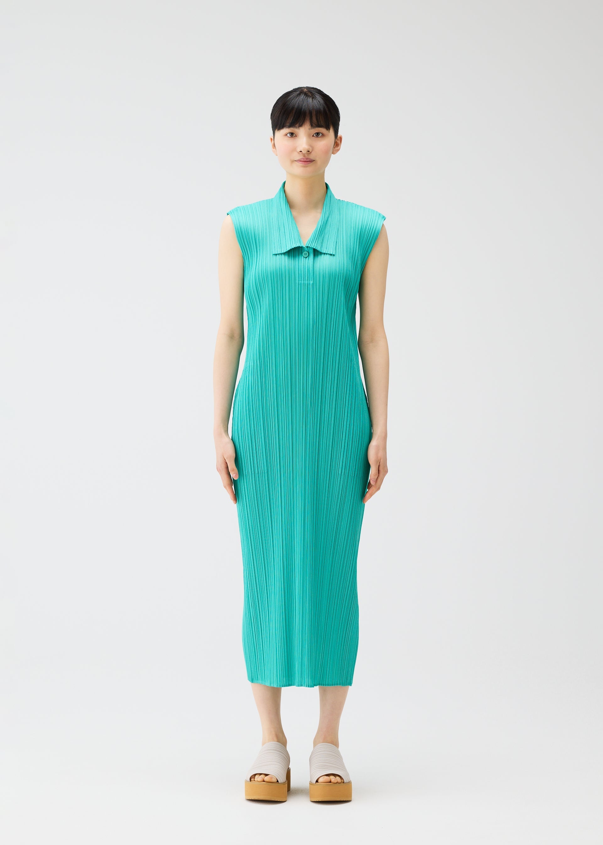 A model wears the PLEATS PLEASE ISSEY MIYAKE MONTHLY COLORS MAY dress.