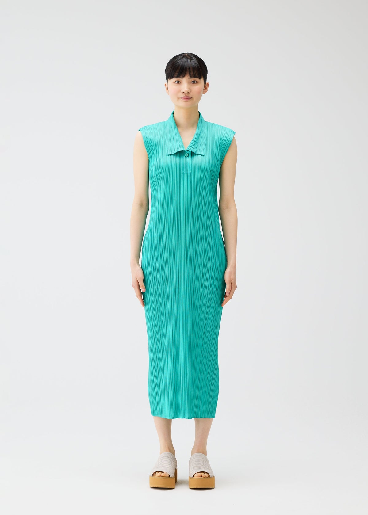 A model wears the PLEATS PLEASE ISSEY MIYAKE MONTHLY COLORS MAY dress.