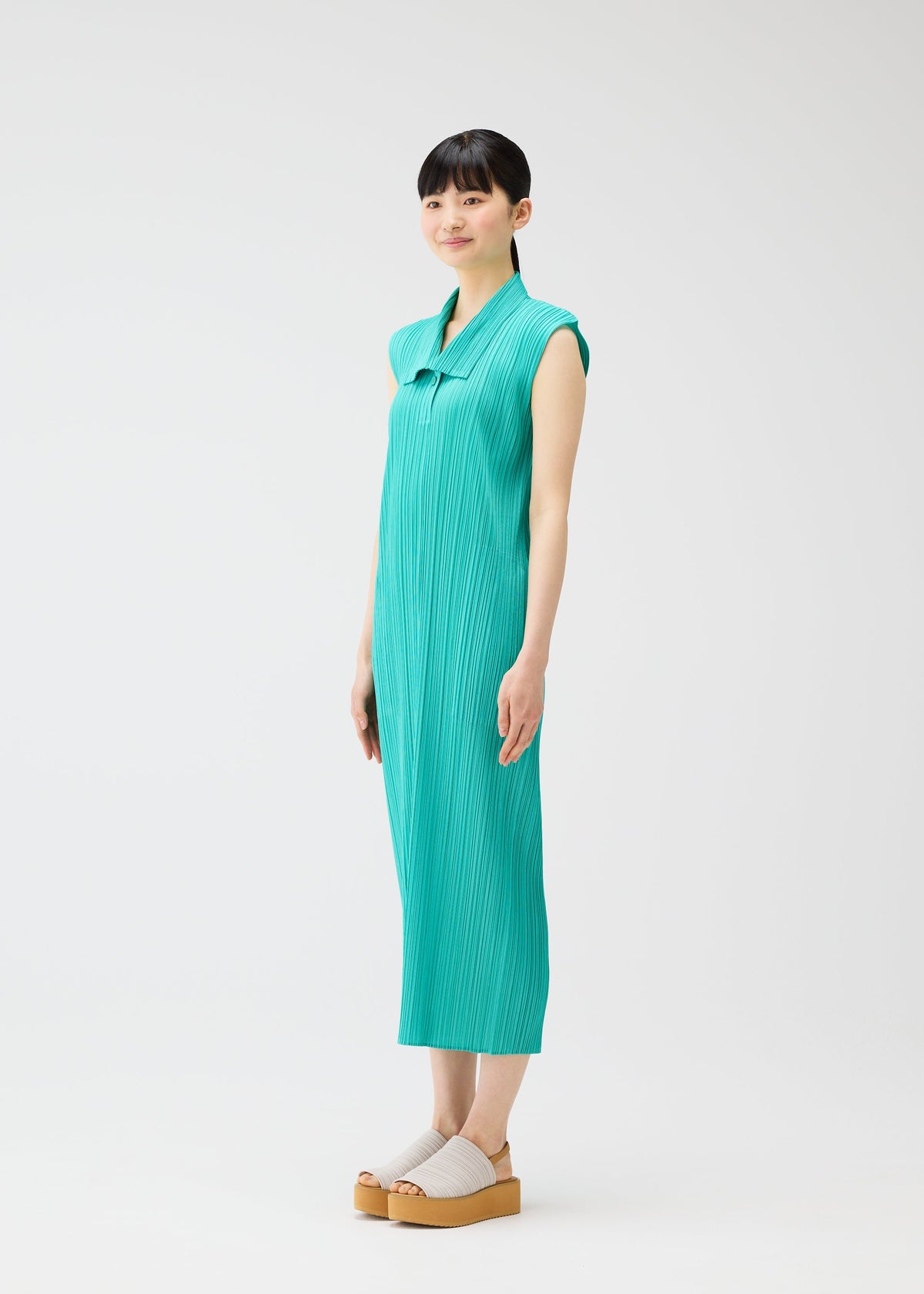 A model wears the PLEATS PLEASE ISSEY MIYAKE MONTHLY COLORS MAY dress.