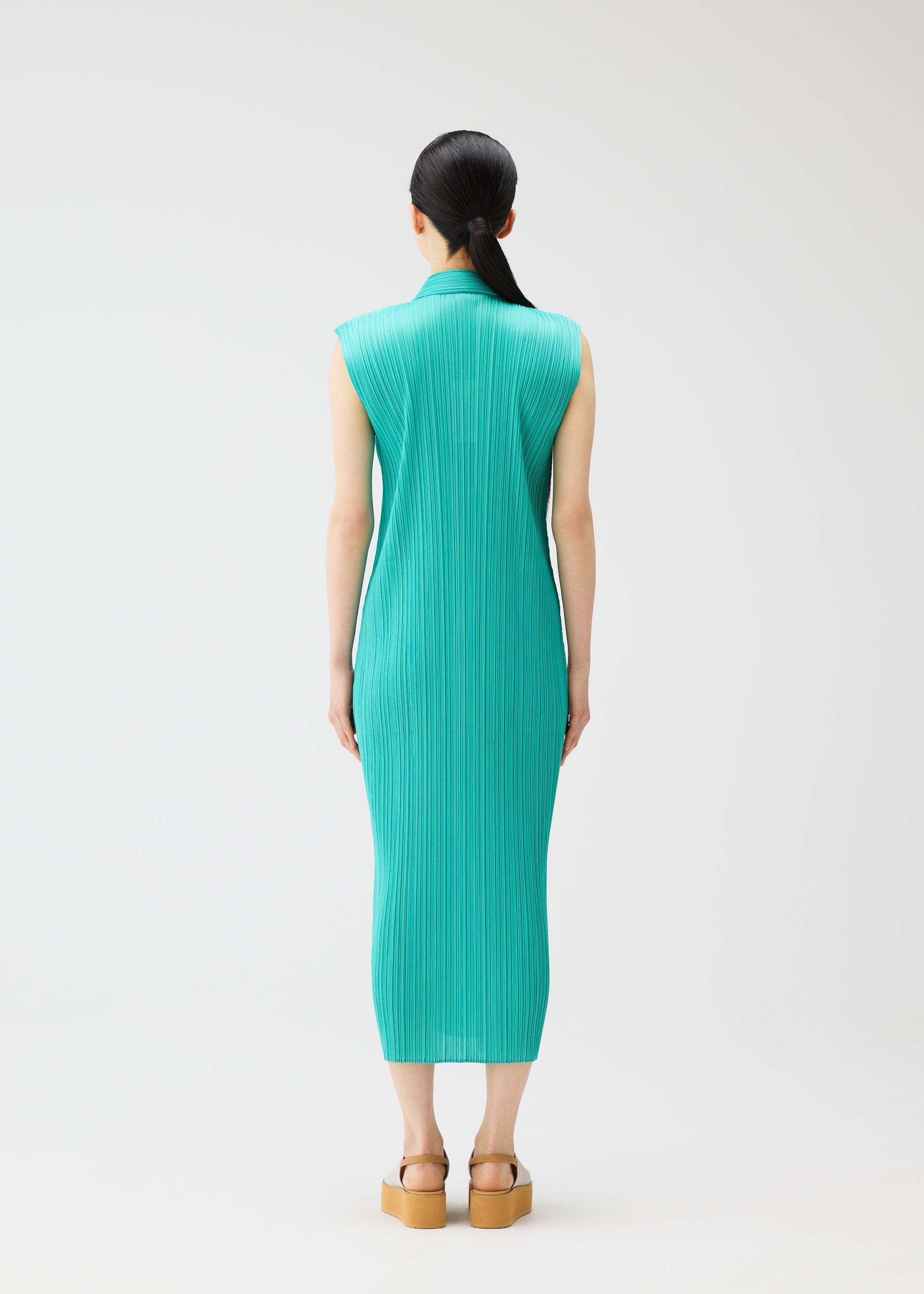 A model wears the PLEATS PLEASE ISSEY MIYAKE MONTHLY COLORS MAY dress.