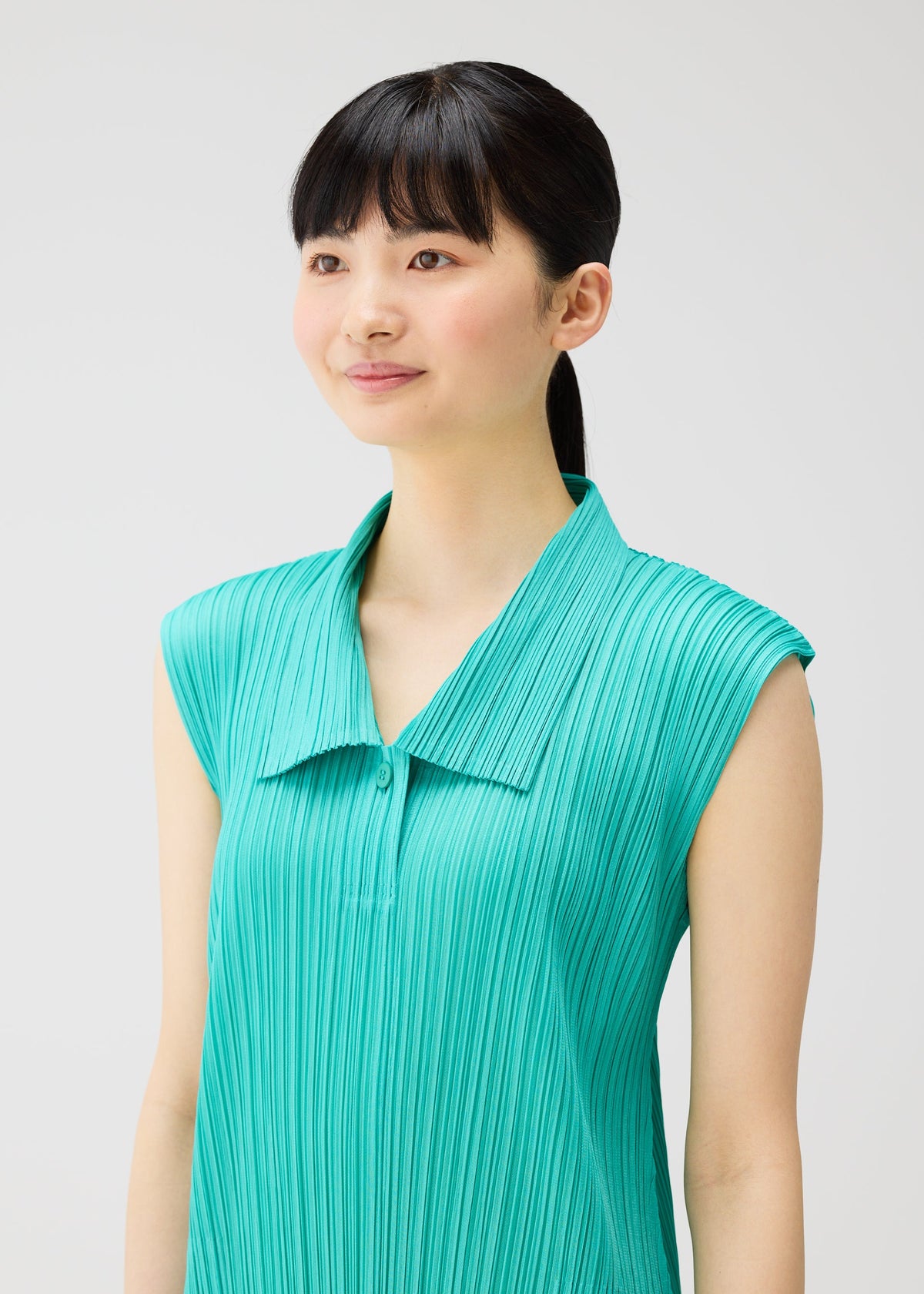 A model wears the PLEATS PLEASE ISSEY MIYAKE MONTHLY COLORS MAY dress.