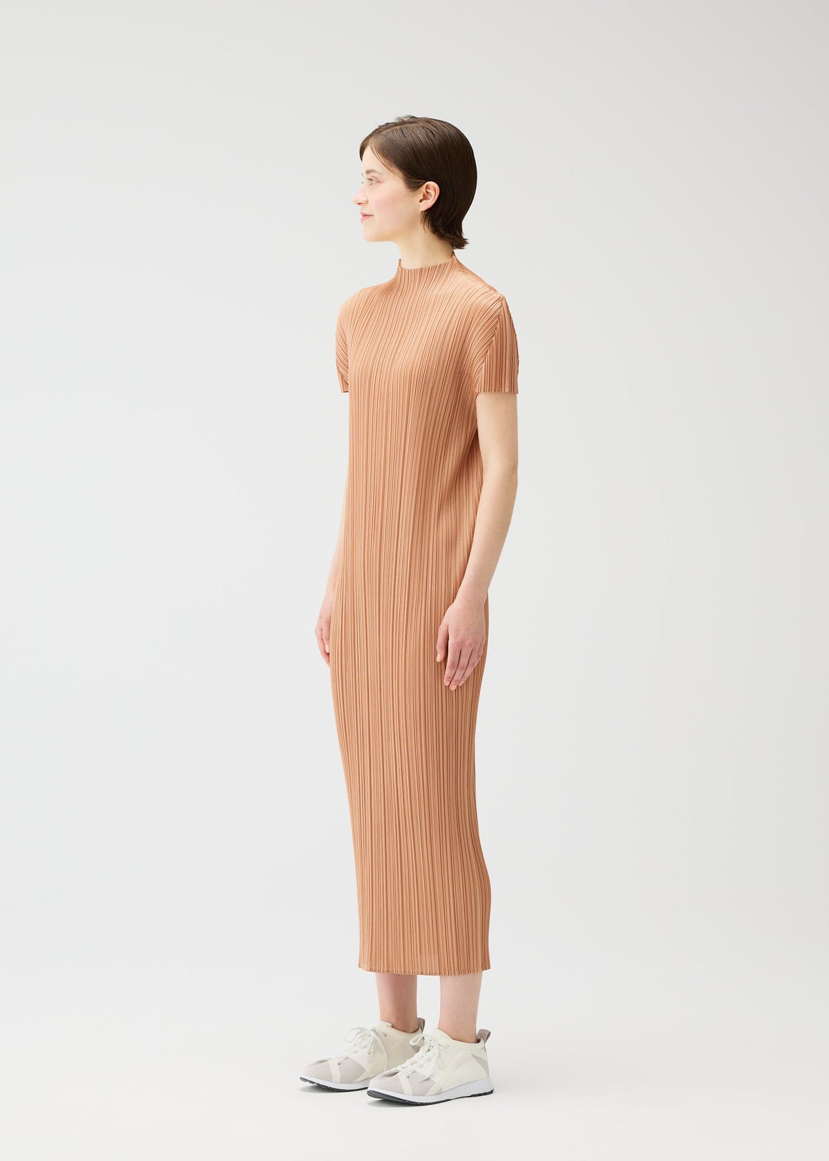 A model wears the PLEATS PLEASE ISSEY MIYAKE MONTHLY COLORS : JUNE monthly-colors-june-dress-bright-pink.