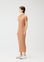 A model wears the PLEATS PLEASE ISSEY MIYAKE MONTHLY COLORS : JUNE monthly-colors-june-dress-bright-pink.