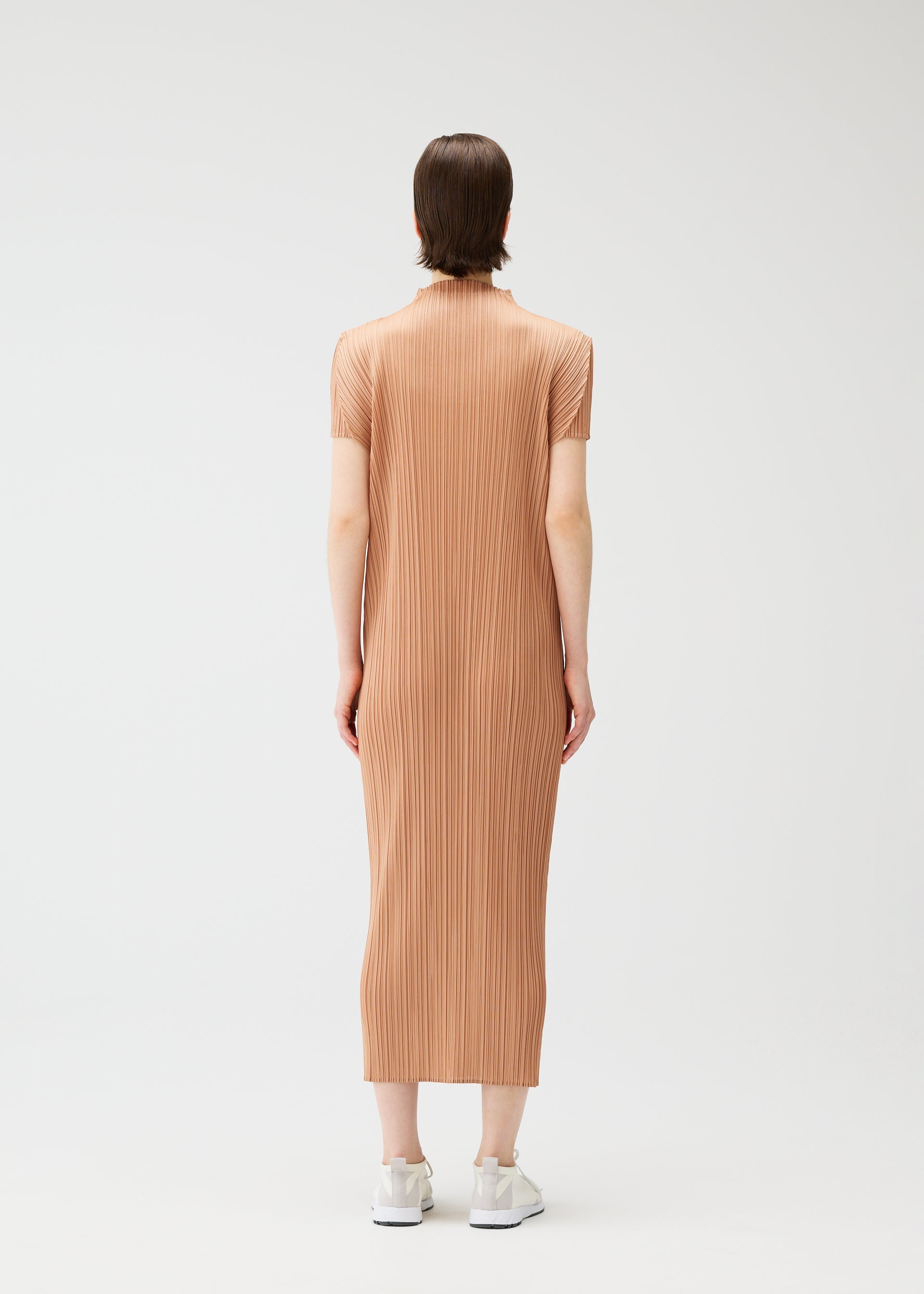 A model wears the PLEATS PLEASE ISSEY MIYAKE MONTHLY COLORS : JUNE monthly-colors-june-dress-pink-beige.