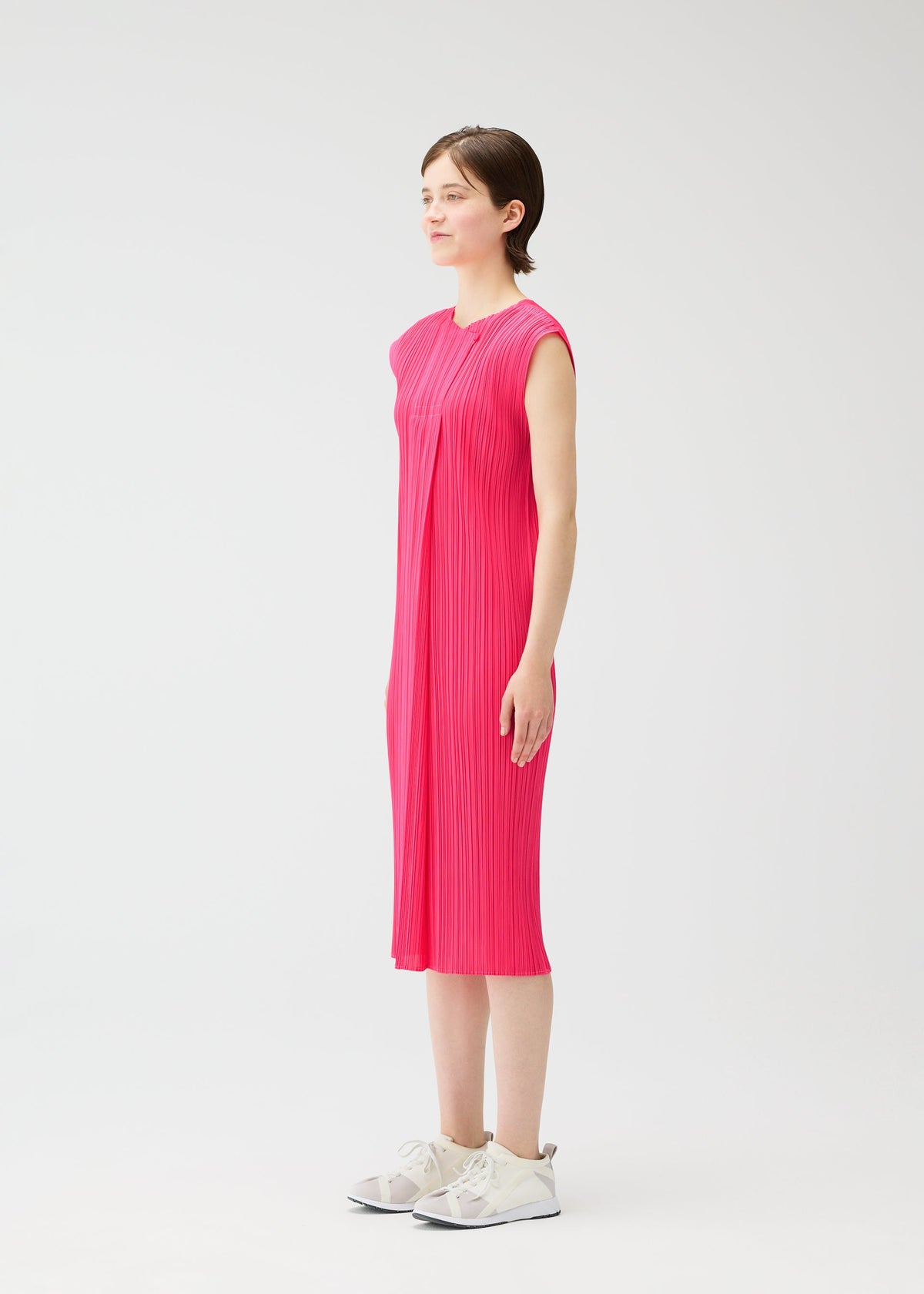 A model wears the PLEATS PLEASE ISSEY MIYAKE MONTHLY COLORS : JUNE monthly-colors-june-dress-yellow-green-1.