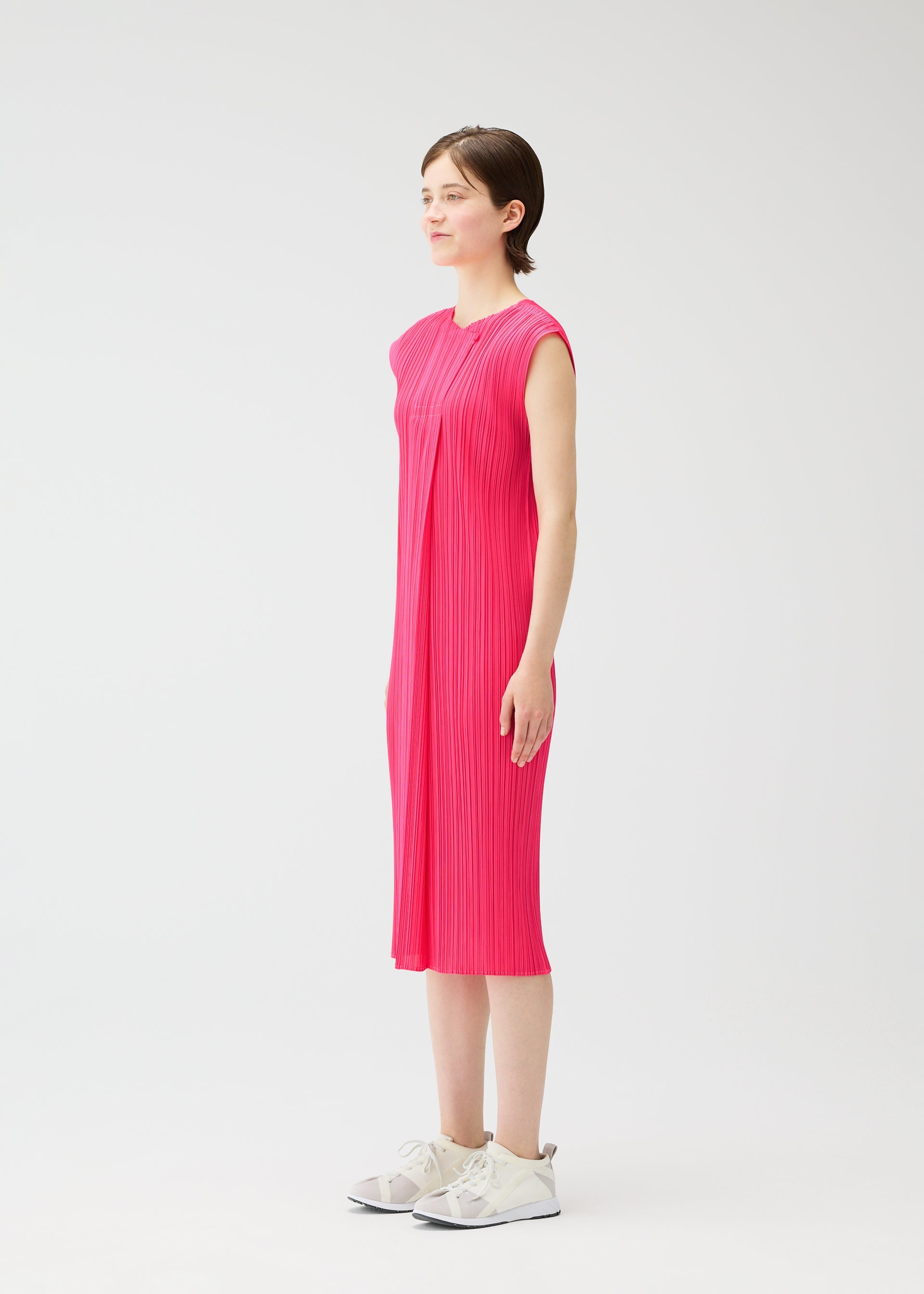 A model wears the PLEATS PLEASE ISSEY MIYAKE MONTHLY COLORS : JUNE monthly-colors-june-dress-bright-pink-1.