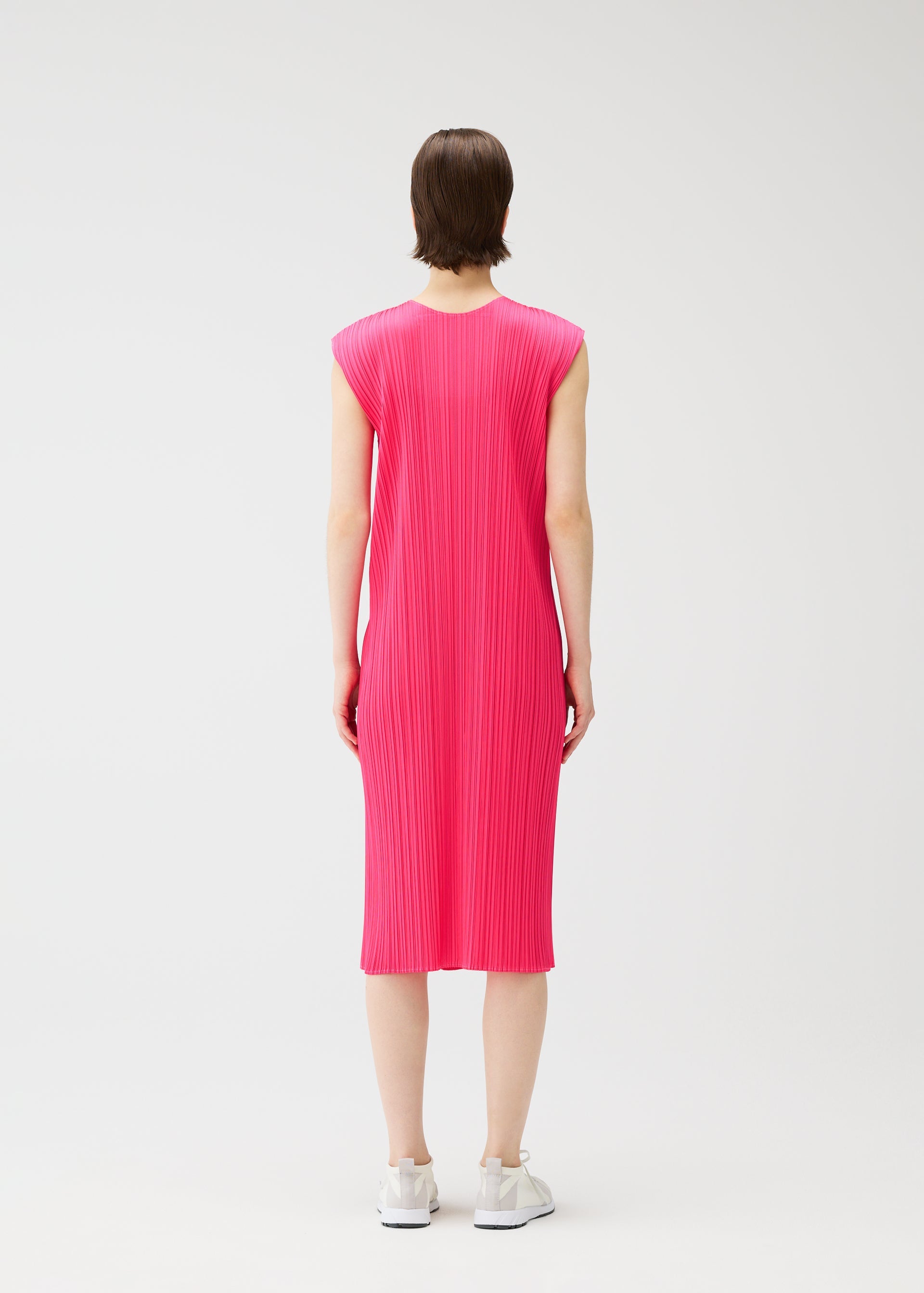 A model wears the PLEATS PLEASE ISSEY MIYAKE MONTHLY COLORS : JUNE monthly-colors-june-dress-pink-beige-1.