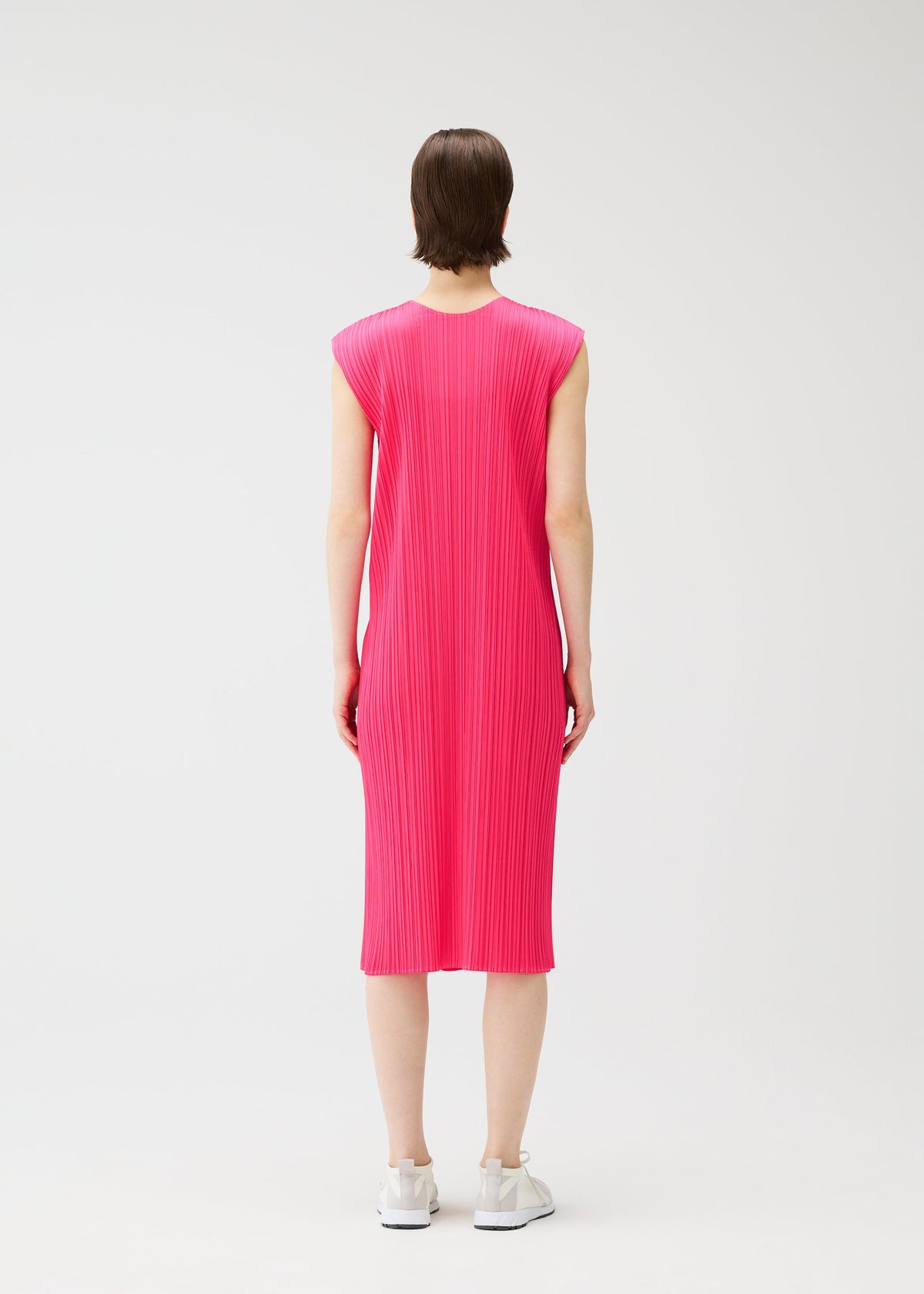 A model wears the PLEATS PLEASE ISSEY MIYAKE MONTHLY COLORS : JUNE monthly-colors-june-dress-bright-pink-1.