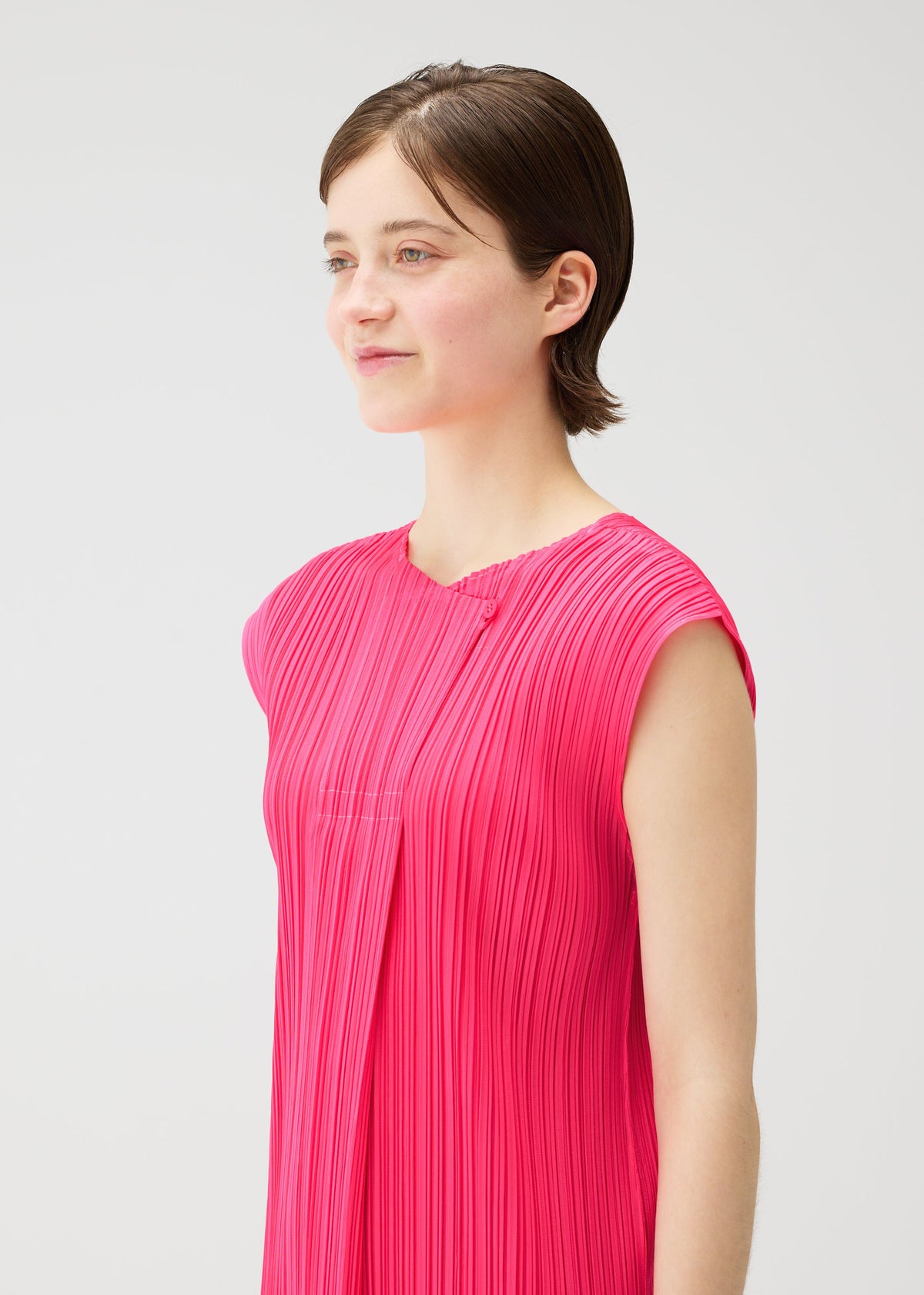 A model wears the PLEATS PLEASE ISSEY MIYAKE MONTHLY COLORS : JUNE monthly-colors-june-dress-charcoal-1.