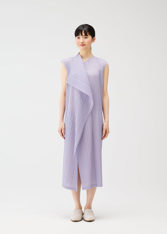 A model wears the PLEATS PLEASE ISSEY MIYAKE RAMIE PLEATS dress.
