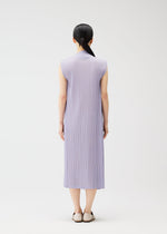 A model wears the PLEATS PLEASE ISSEY MIYAKE RAMIE PLEATS dress.
