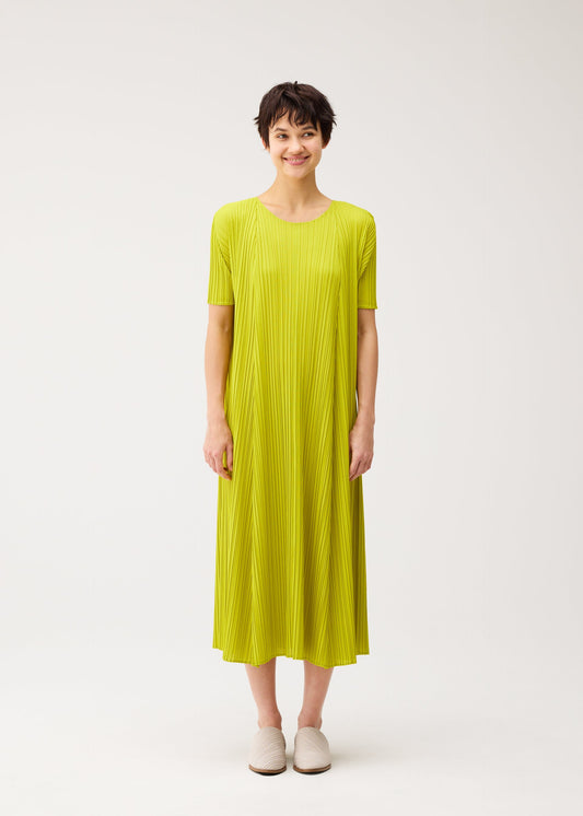 A model wears the PLEATS PLEASE ISSEY MIYAKE MELLOW PLEATS dress.