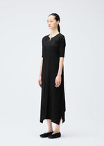 A model wears the PLEATS PLEASE ISSEY MIYAKE MELLOW PLEATS dress.