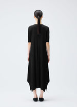 A model wears the PLEATS PLEASE ISSEY MIYAKE MELLOW PLEATS dress.
