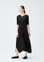 A model wears the PLEATS PLEASE ISSEY MIYAKE MELLOW PLEATS dress.