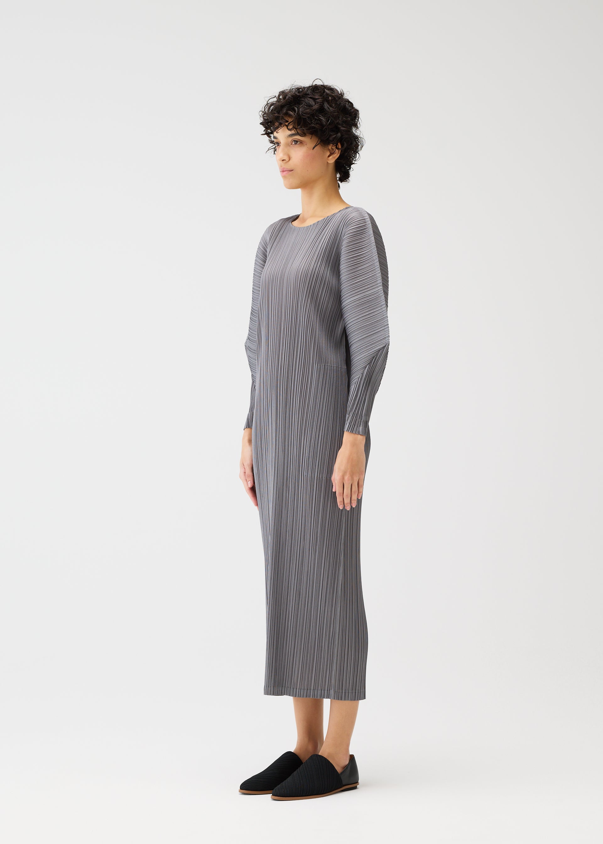 A model wears the PLEATS PLEASE ISSEY MIYAKE SKYLINE clothing.