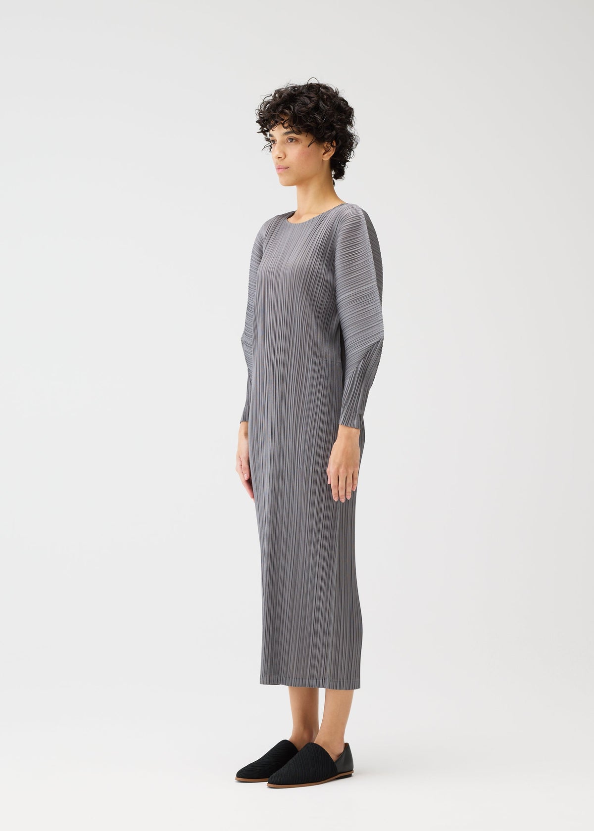 A model wears the PLEATS PLEASE ISSEY MIYAKE SKYLINE clothing.