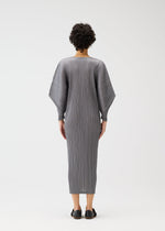 A model wears the PLEATS PLEASE ISSEY MIYAKE SKYLINE clothing.