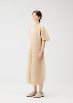 A model wears the PLEATS PLEASE ISSEY MIYAKE COAST dress.