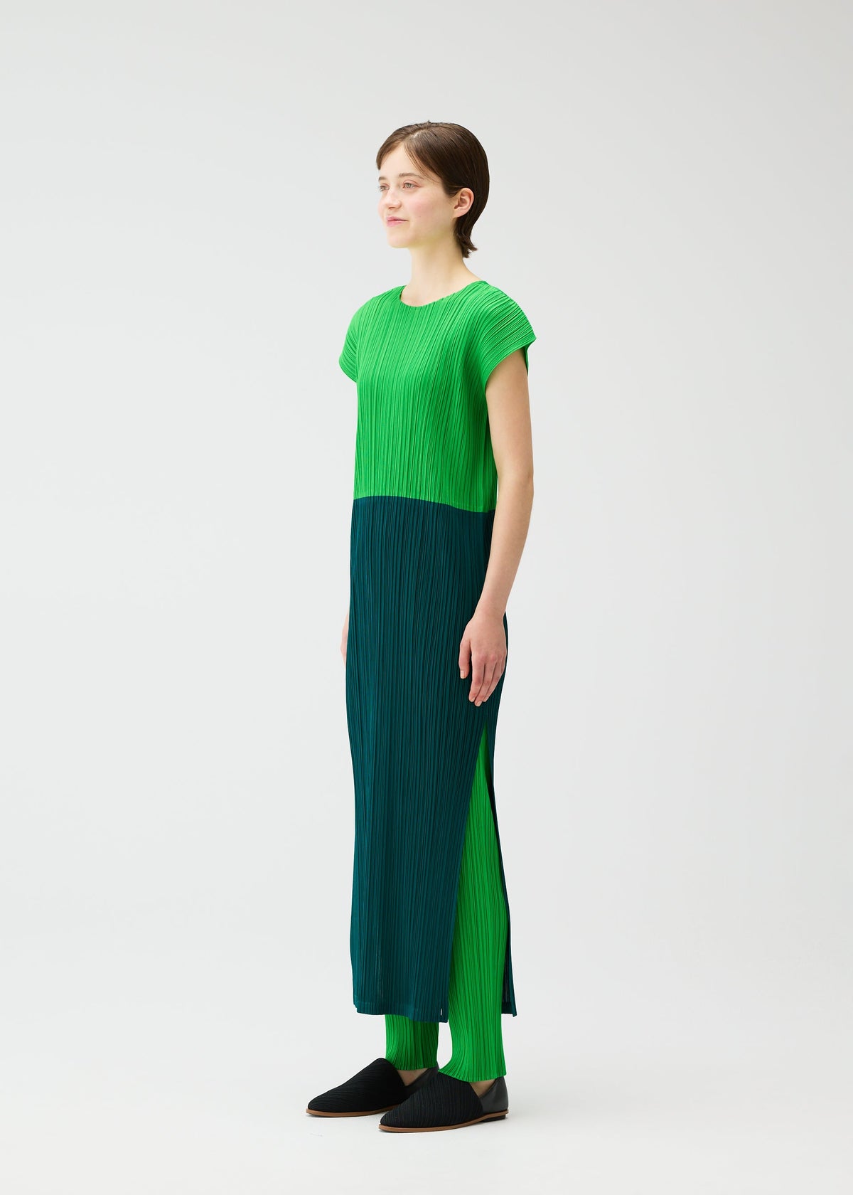 A model wears the PLEATS PLEASE ISSEY MIYAKE SWING dress.