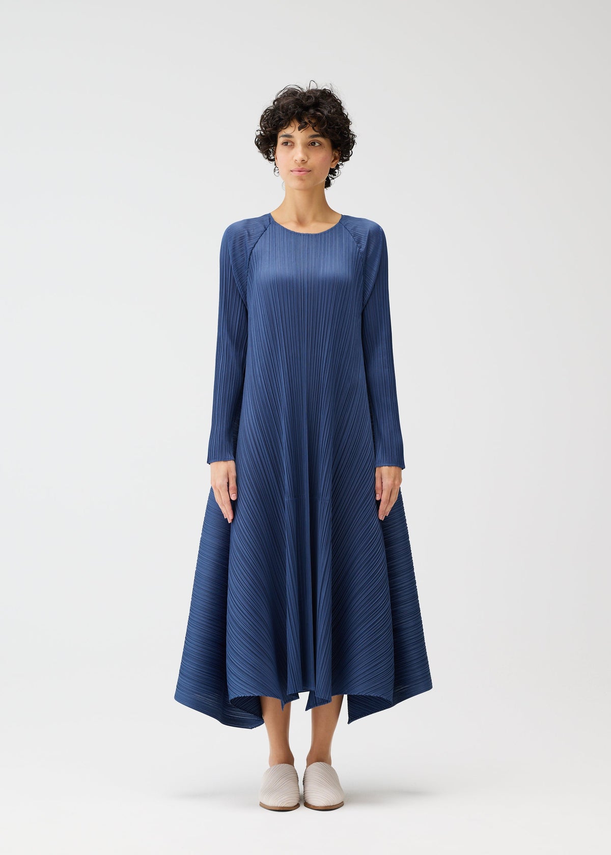 A model wears the PLEATS PLEASE ISSEY MIYAKE CITY FRAME dress.