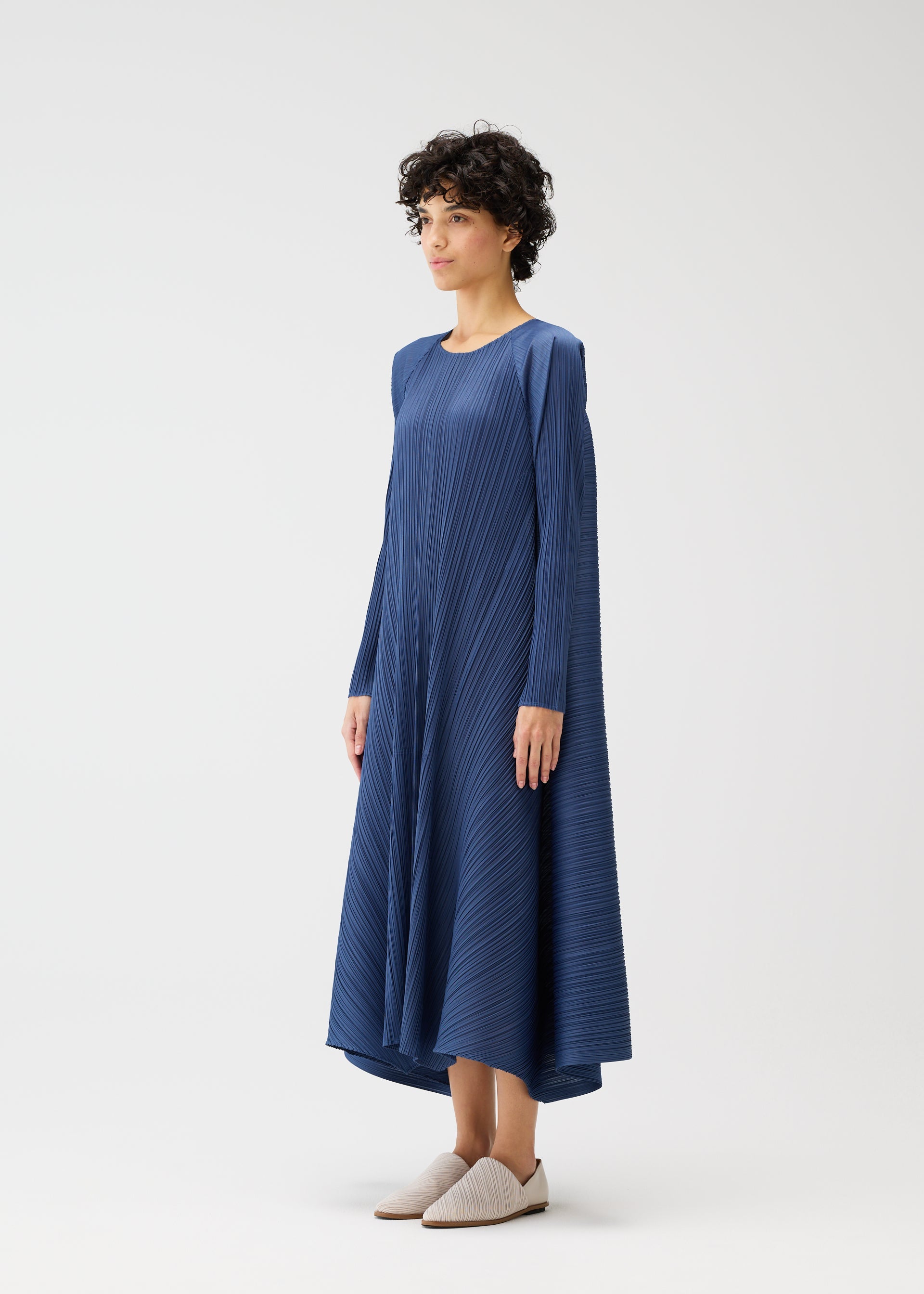 A model wears the PLEATS PLEASE ISSEY MIYAKE CITY FRAME dress.