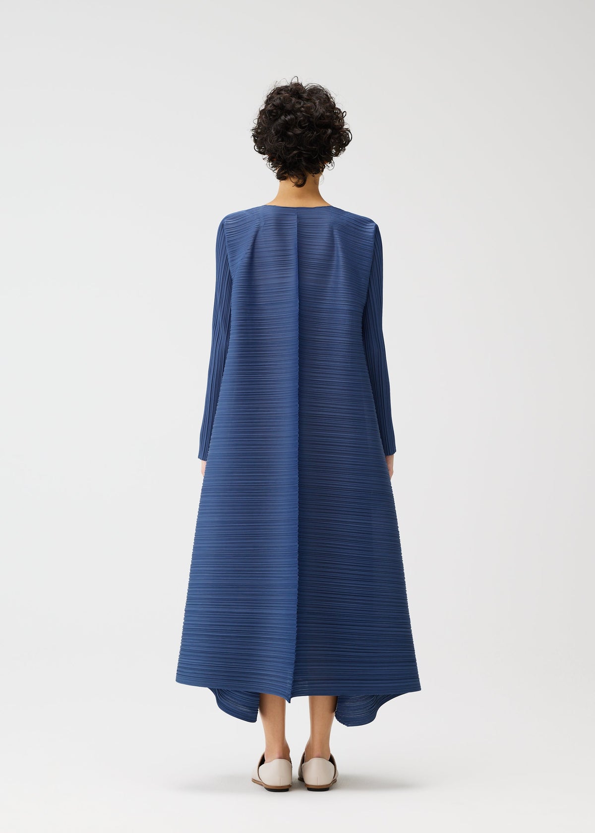 A model wears the PLEATS PLEASE ISSEY MIYAKE CITY FRAME dress.
