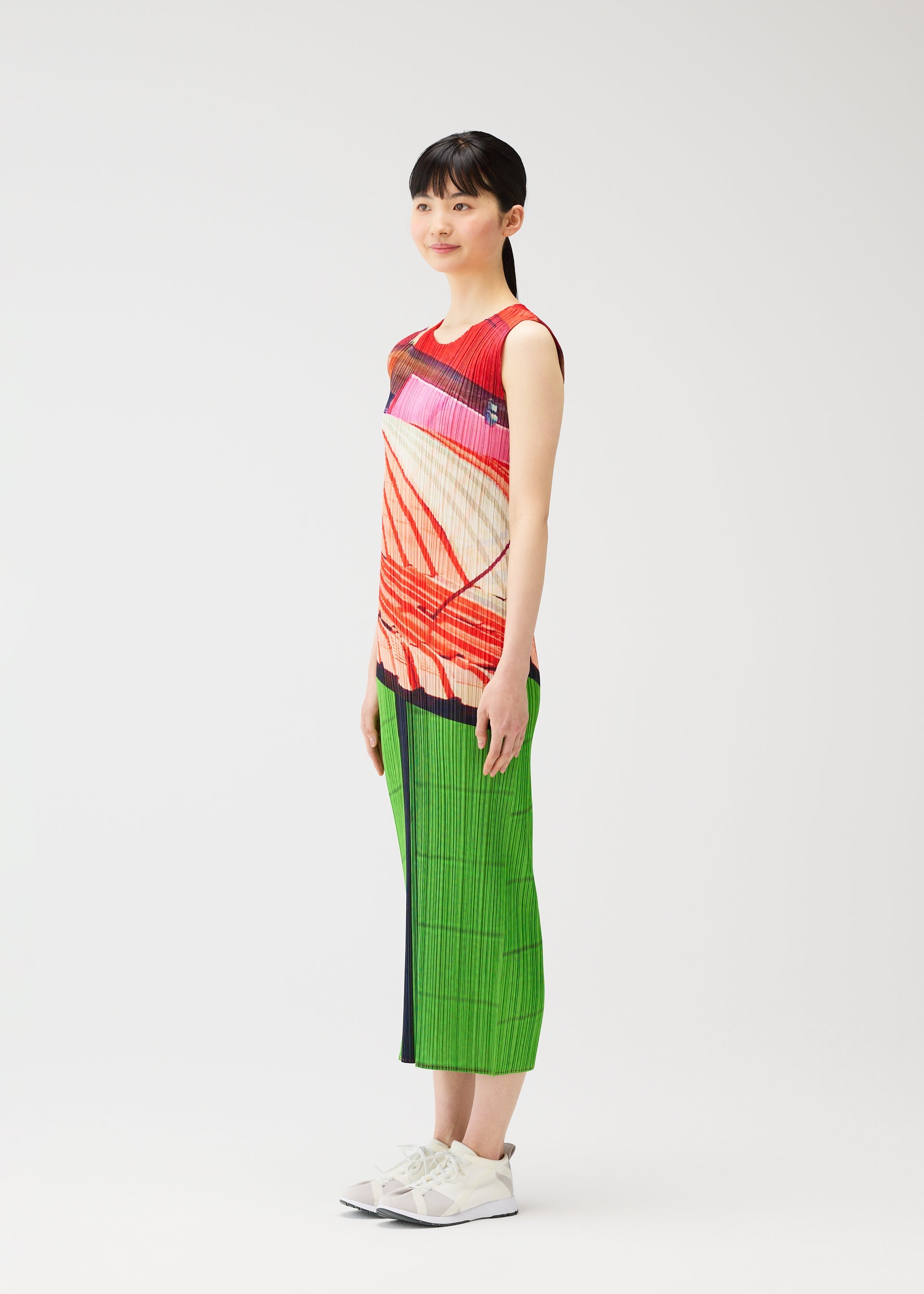 A model wears the PLEATS PLEASE ISSEY MIYAKE CITY COLLAGE clothing.