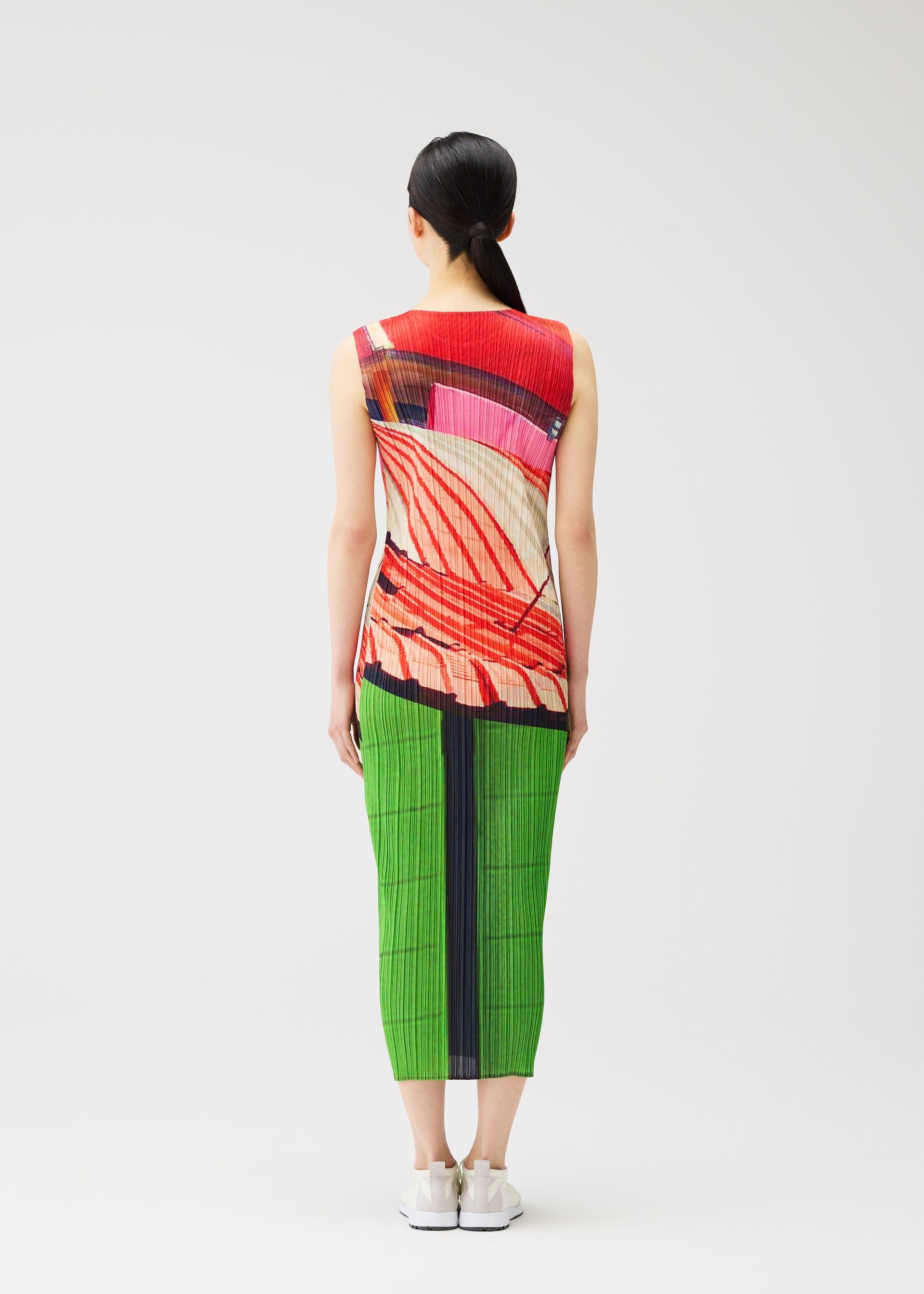 A model wears the PLEATS PLEASE ISSEY MIYAKE CITY COLLAGE clothing.