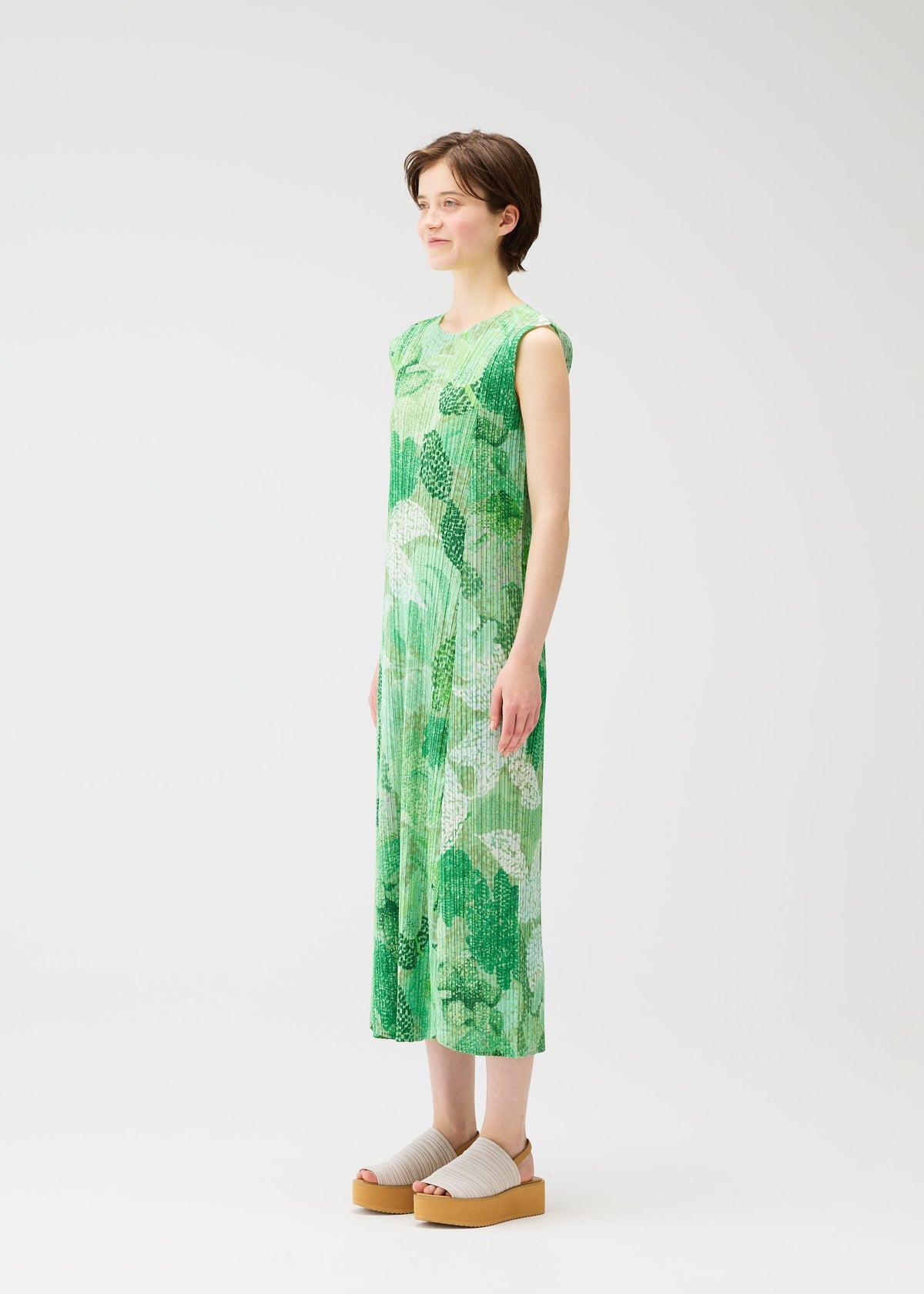 A model wears the PLEATS PLEASE ISSEY MIYAKE FOGGY FOREST dress.