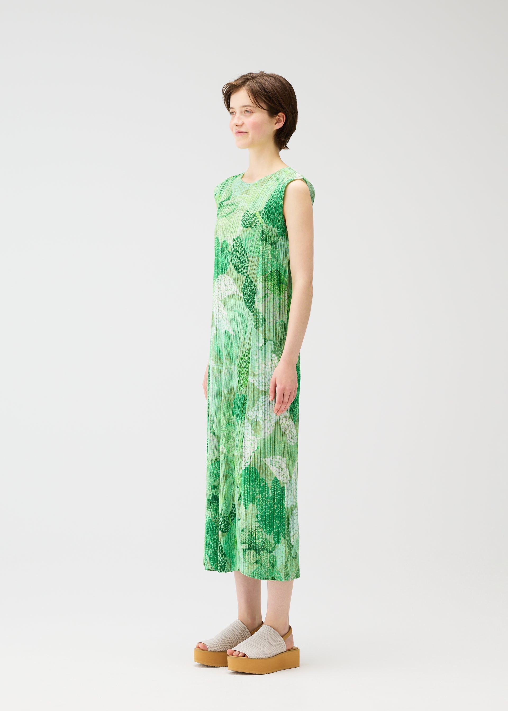 A model wears the PLEATS PLEASE ISSEY MIYAKE FOGGY FOREST dress.