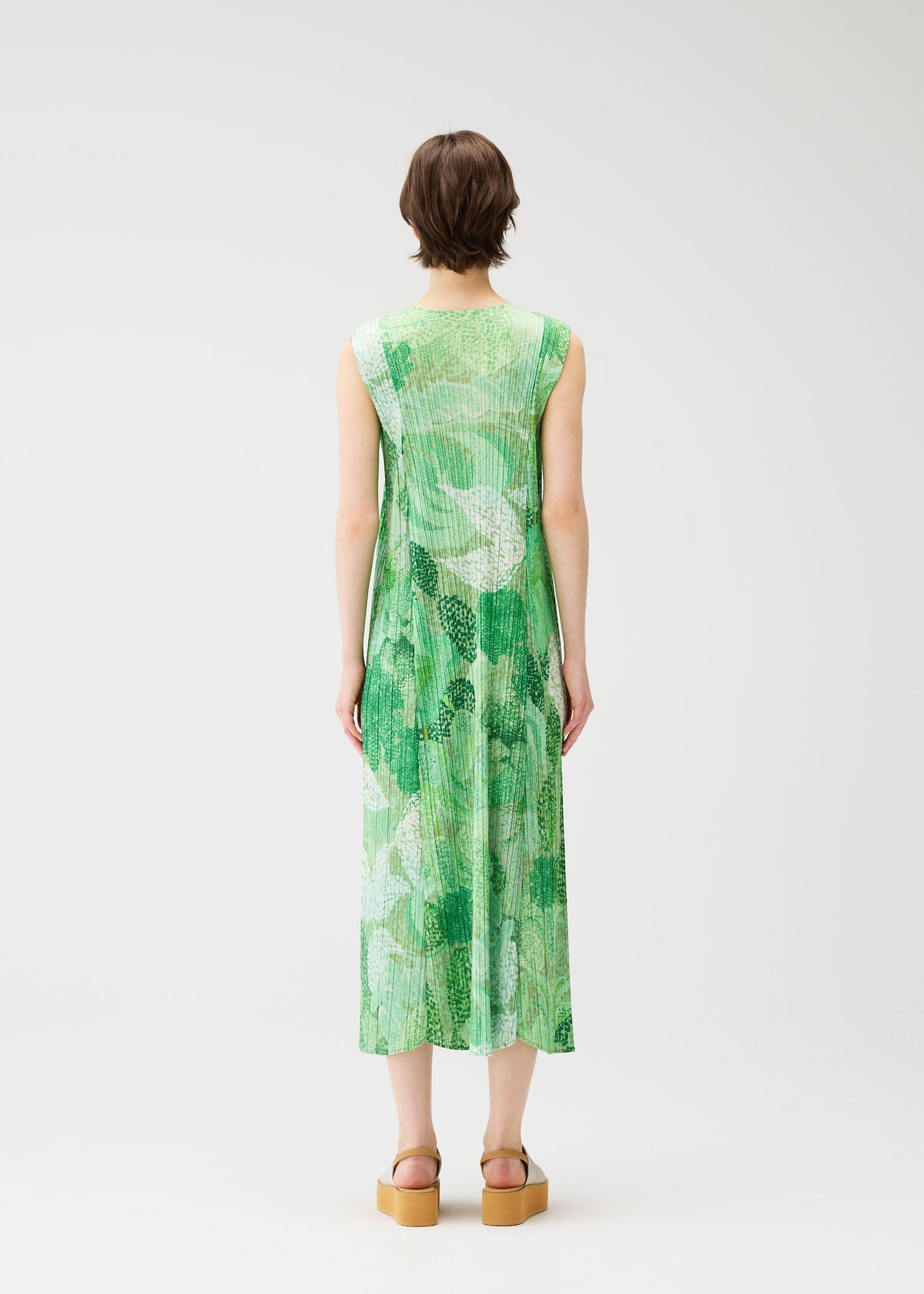 A model wears the PLEATS PLEASE ISSEY MIYAKE FOGGY FOREST dress.