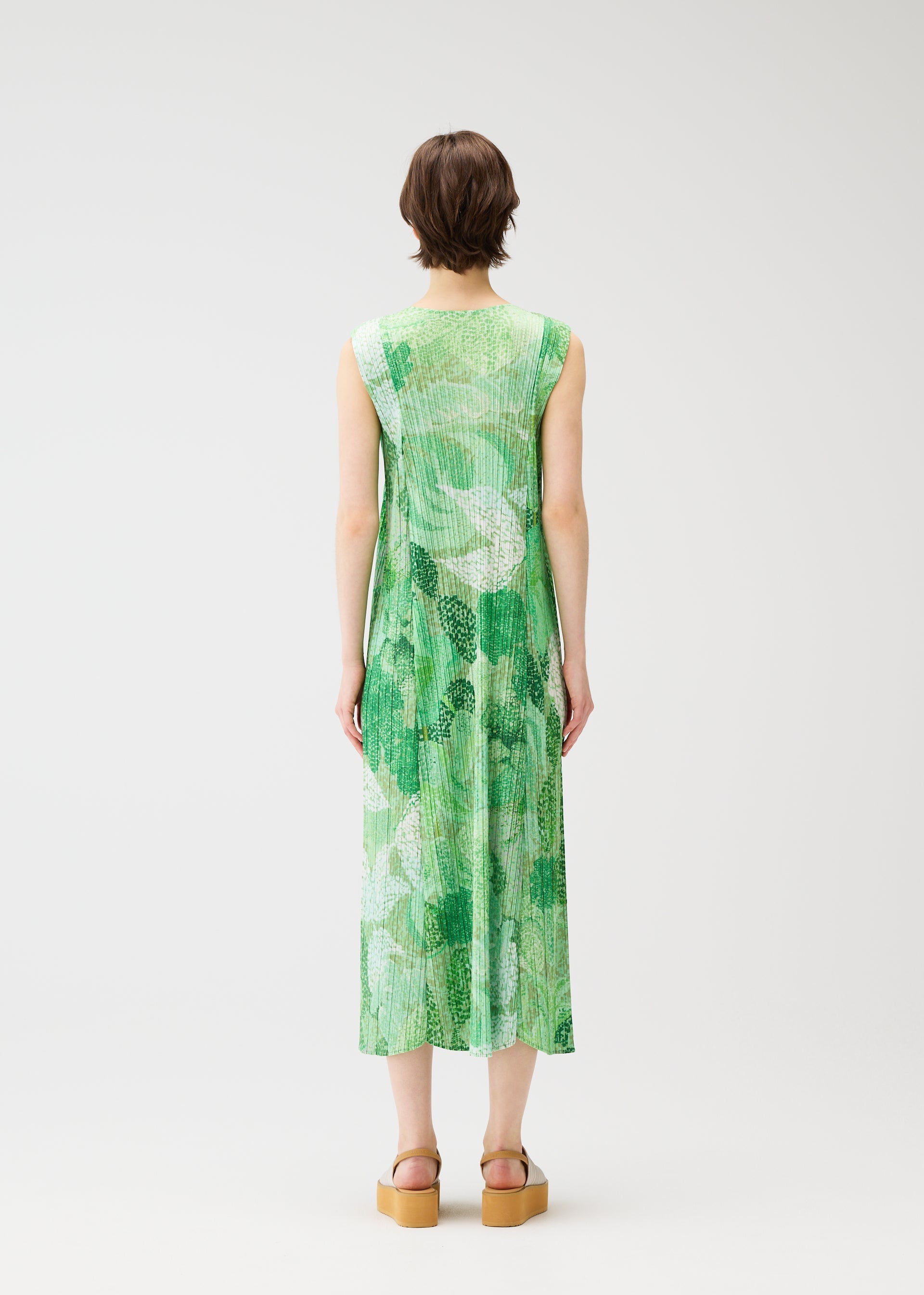 A model wears the PLEATS PLEASE ISSEY MIYAKE FOGGY FOREST dress.