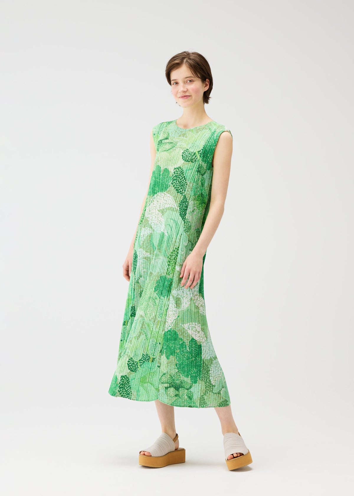 A model wears the PLEATS PLEASE ISSEY MIYAKE FOGGY FOREST dress.