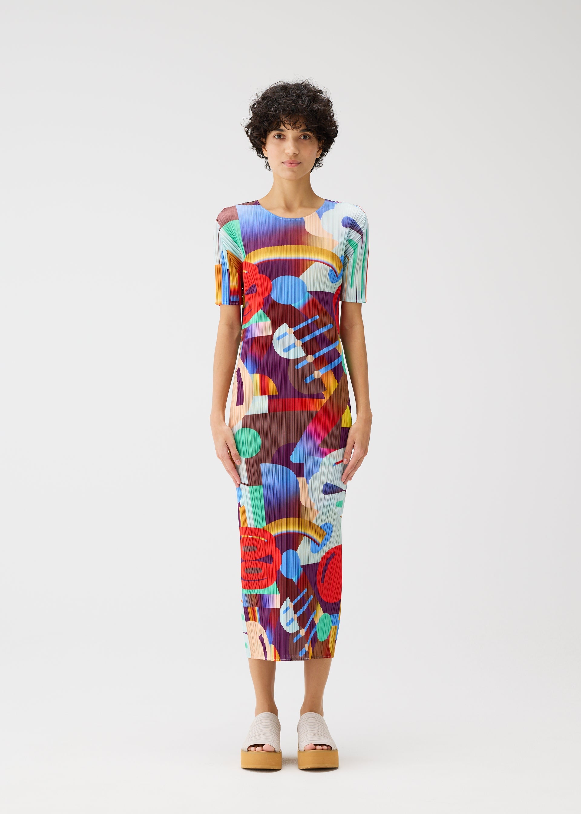 A model wears the PLEATS PLEASE ISSEY MIYAKE PLAYGROUND dress.