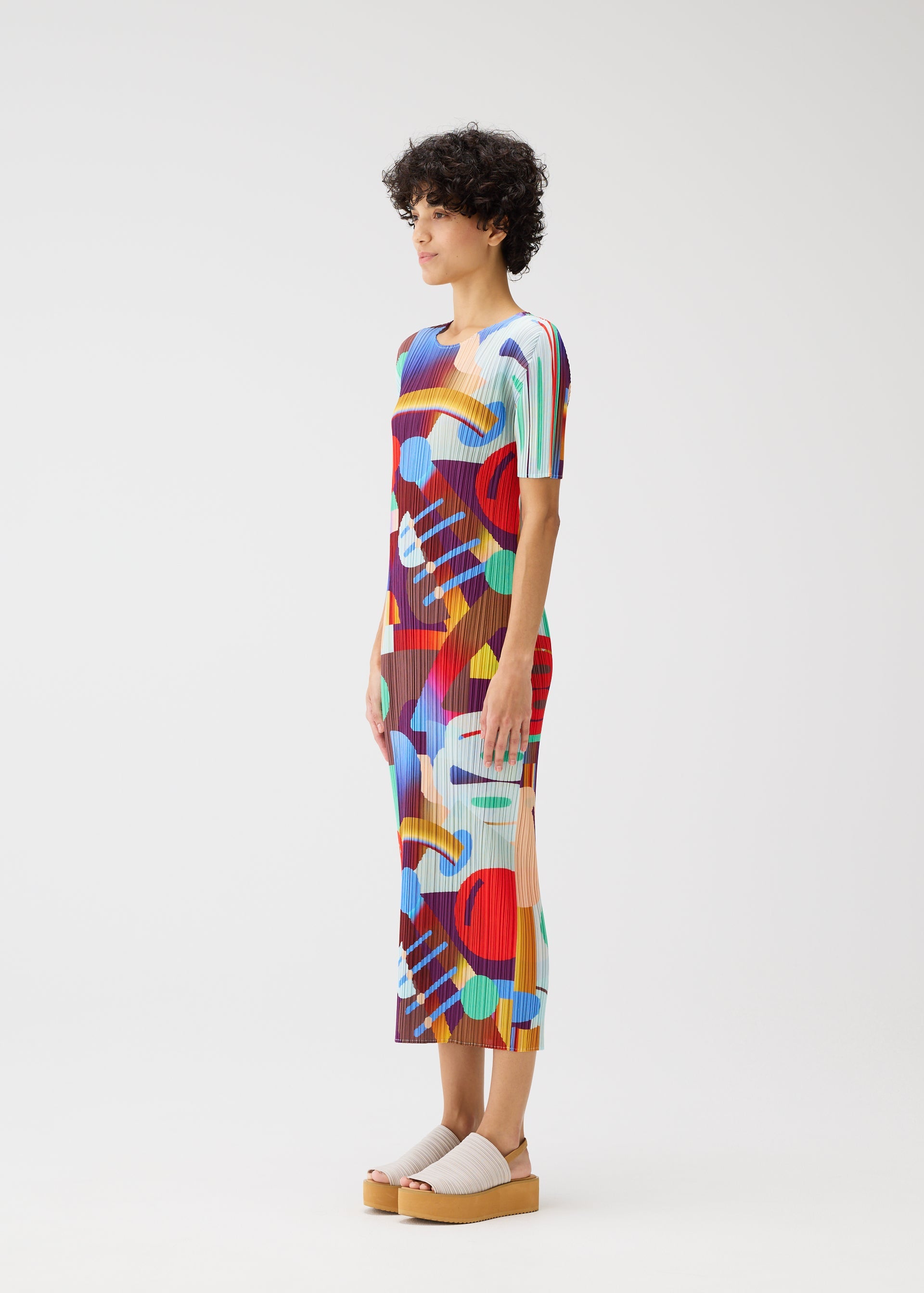 A model wears the PLEATS PLEASE ISSEY MIYAKE PLAYGROUND dress.