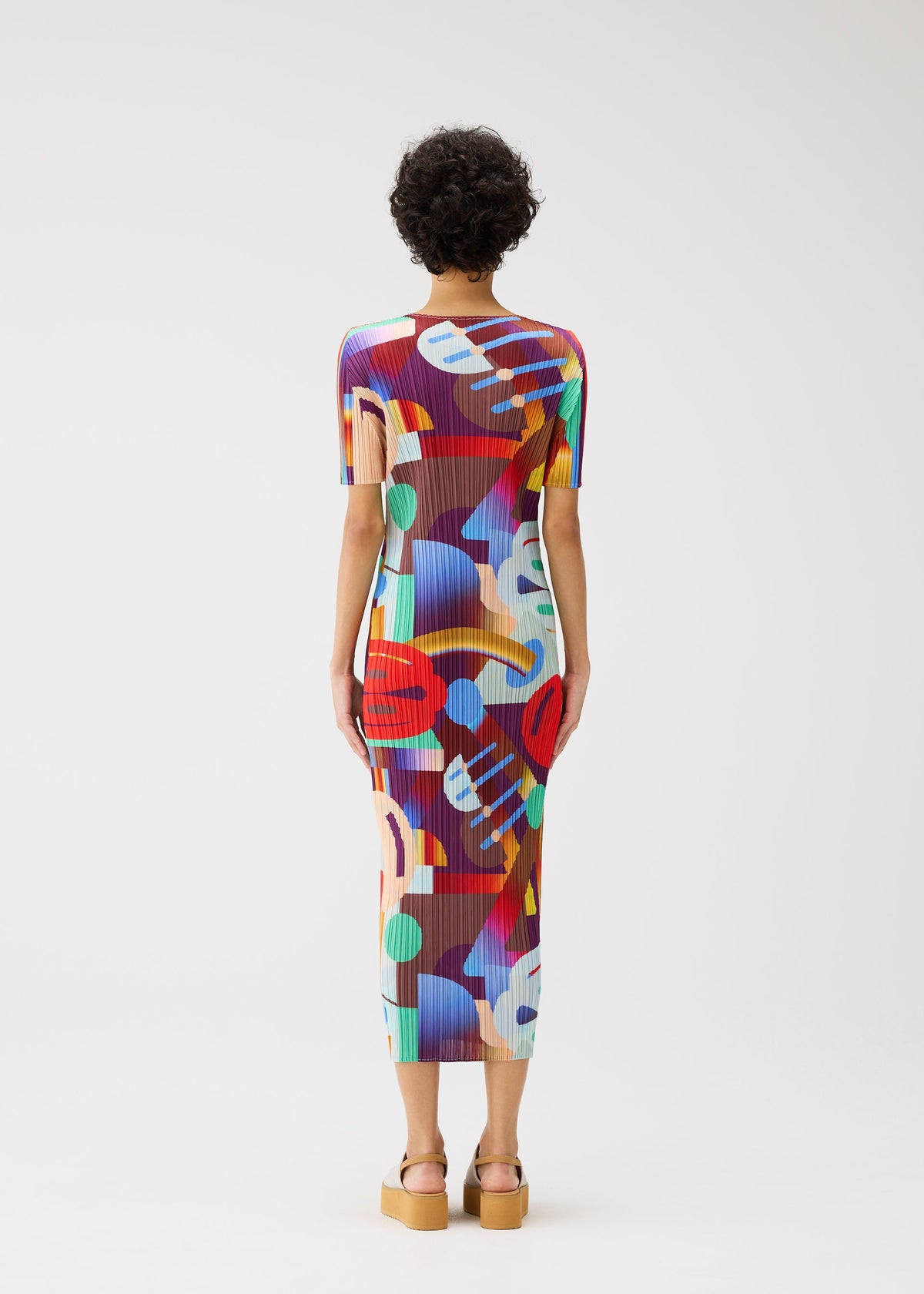 A model wears the PLEATS PLEASE ISSEY MIYAKE PLAYGROUND dress.