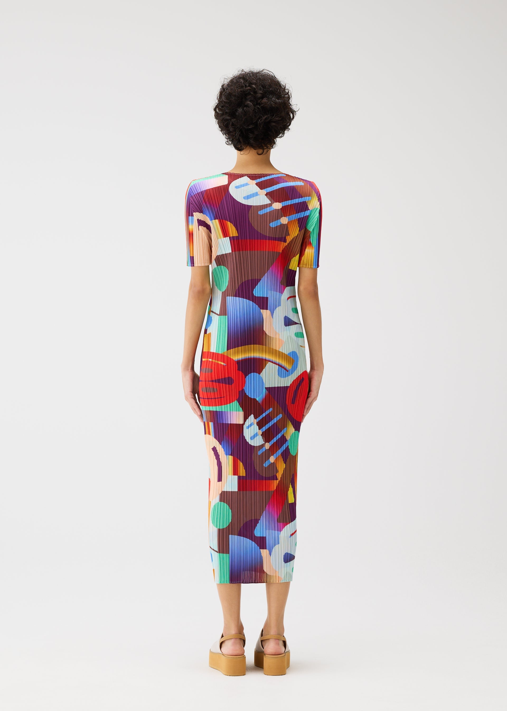 A model wears the PLEATS PLEASE ISSEY MIYAKE PLAYGROUND dress.