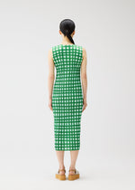 A model wears the PLEATS PLEASE ISSEY MIYAKE BASKET basket-dress-green.