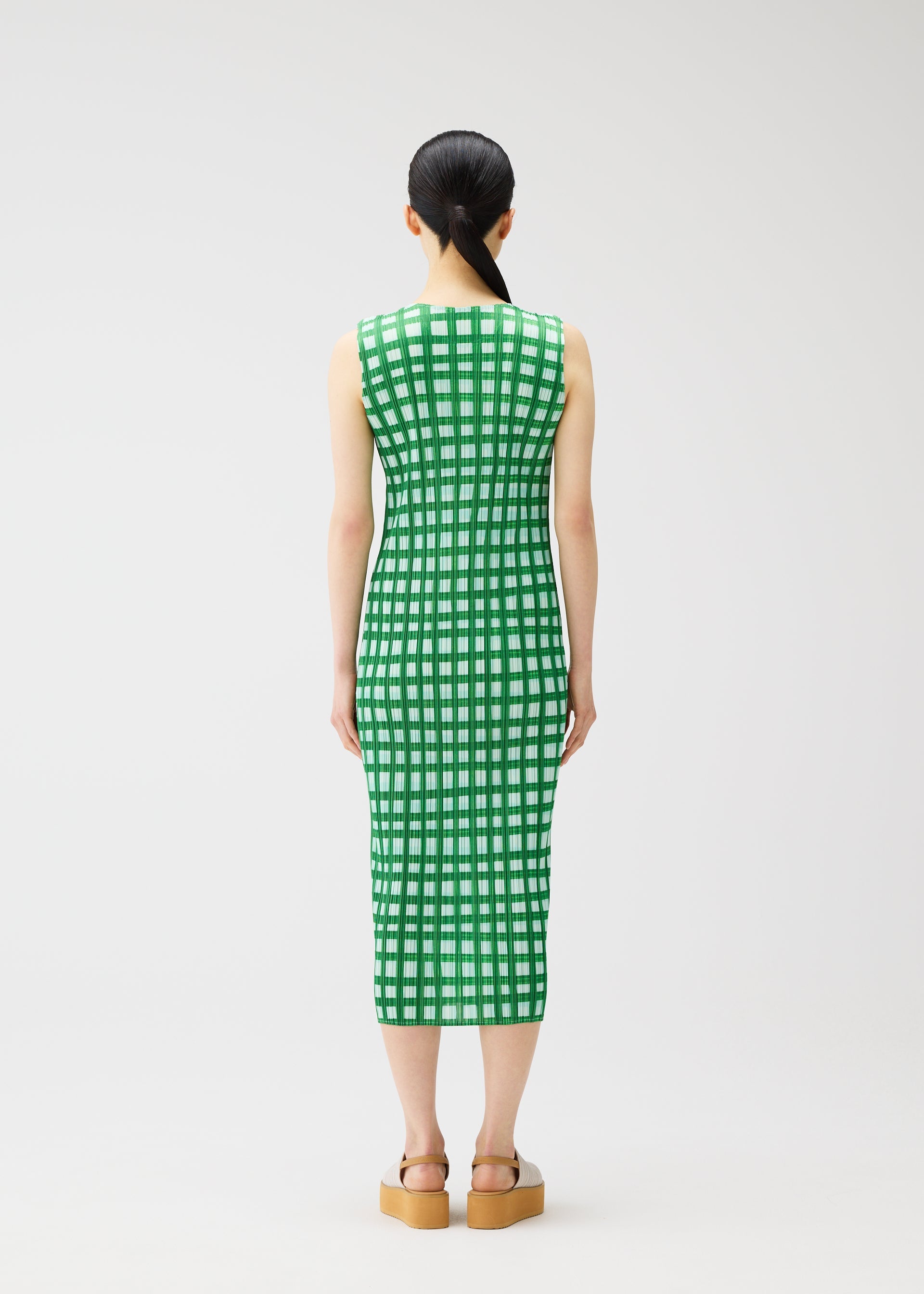 A model wears the PLEATS PLEASE ISSEY MIYAKE BASKET basket-dress-navy.