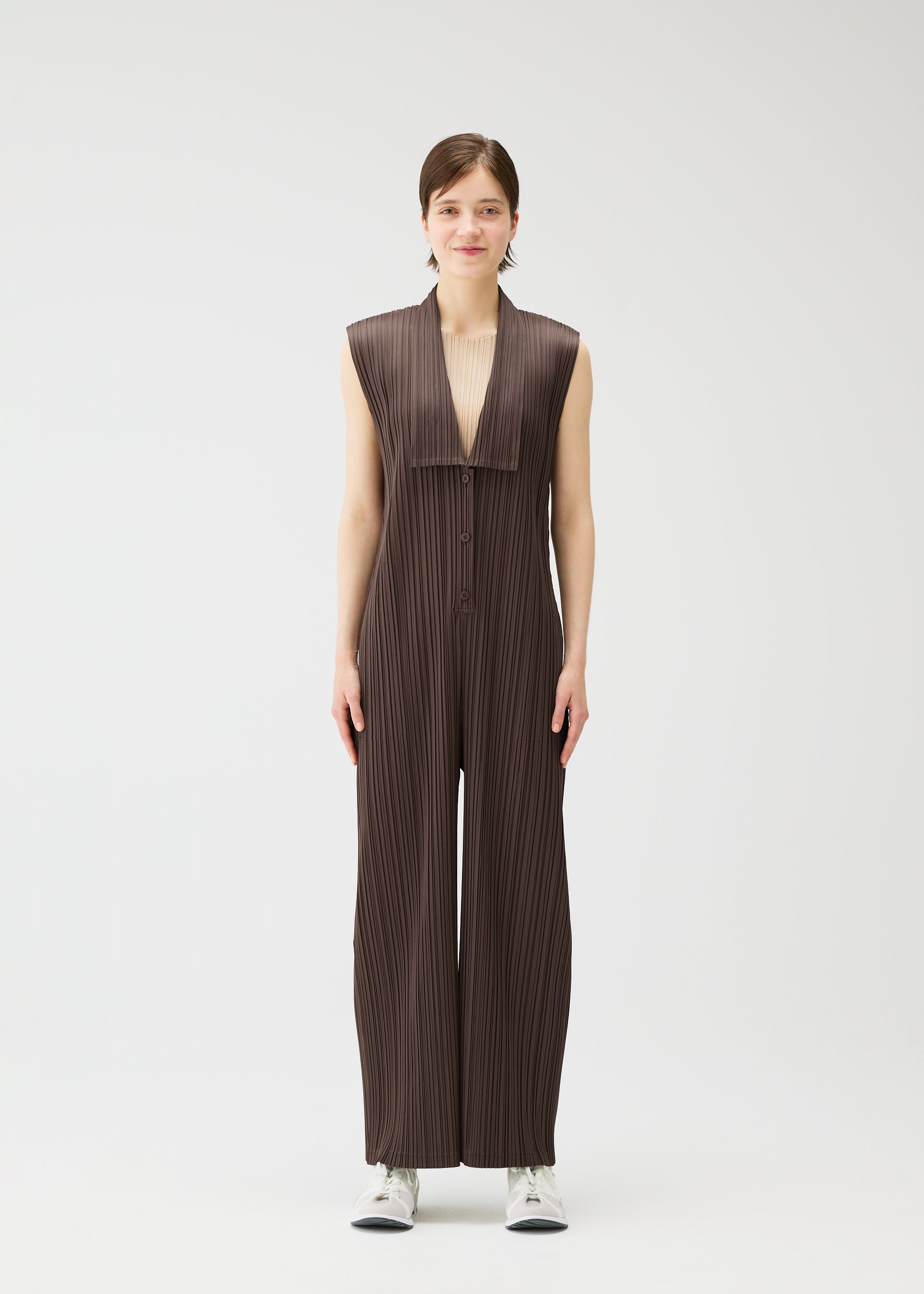 A model wears the PLEATS PLEASE ISSEY MIYAKE LOOP BOTTOMS jumpsuit.