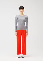 A model wears the PLEATS PLEASE ISSEY MIYAKE MONTHLY COLORS FEBRUARY shirt.
