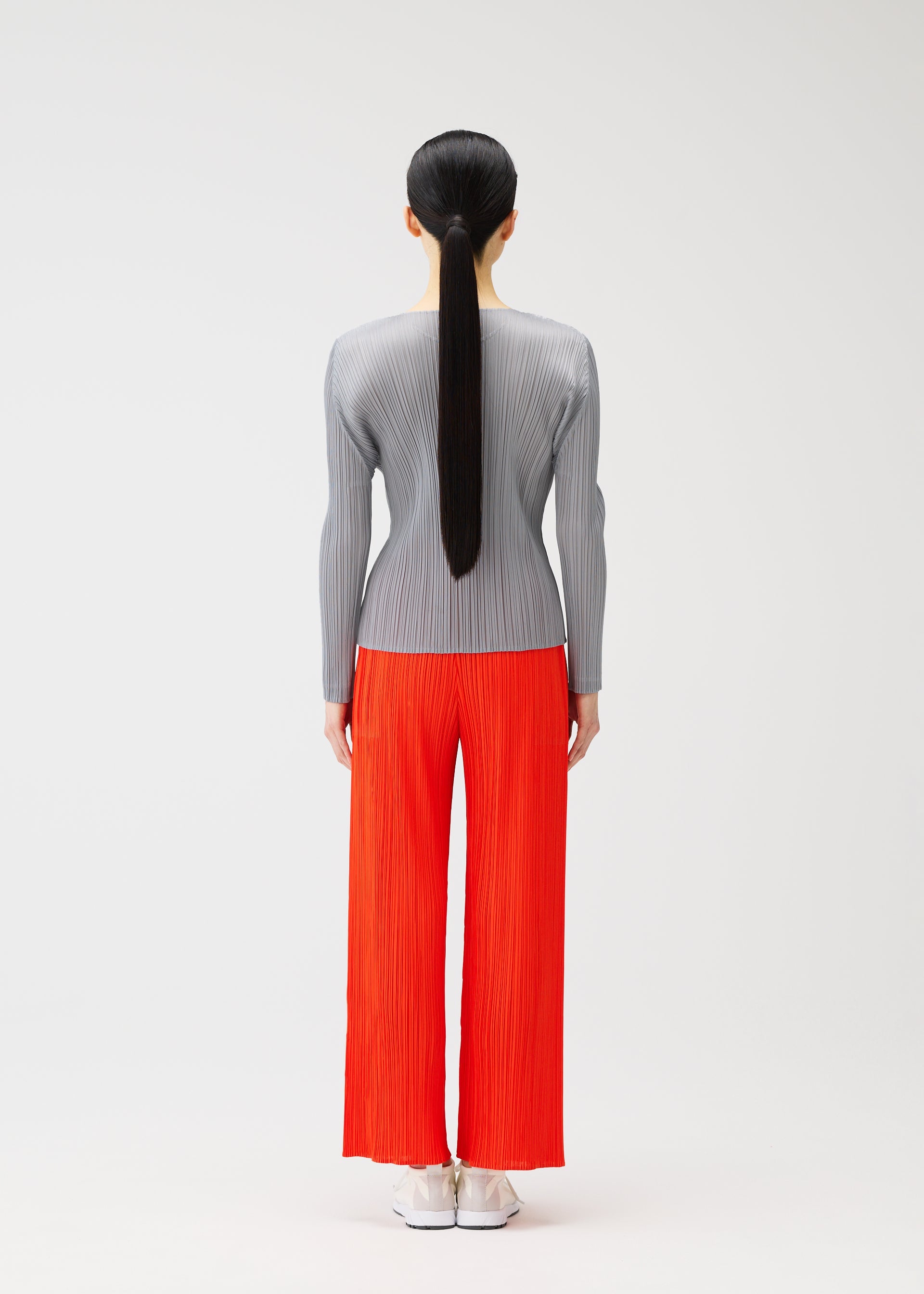 A model wears the PLEATS PLEASE ISSEY MIYAKE MONTHLY COLORS FEBRUARY shirt.