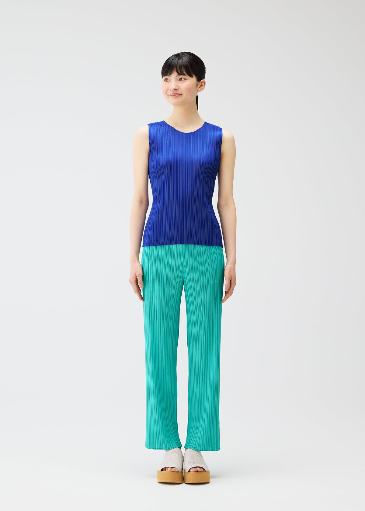 A model wears the PLEATS PLEASE ISSEY MIYAKE MONTHLY COLORS MAY top.